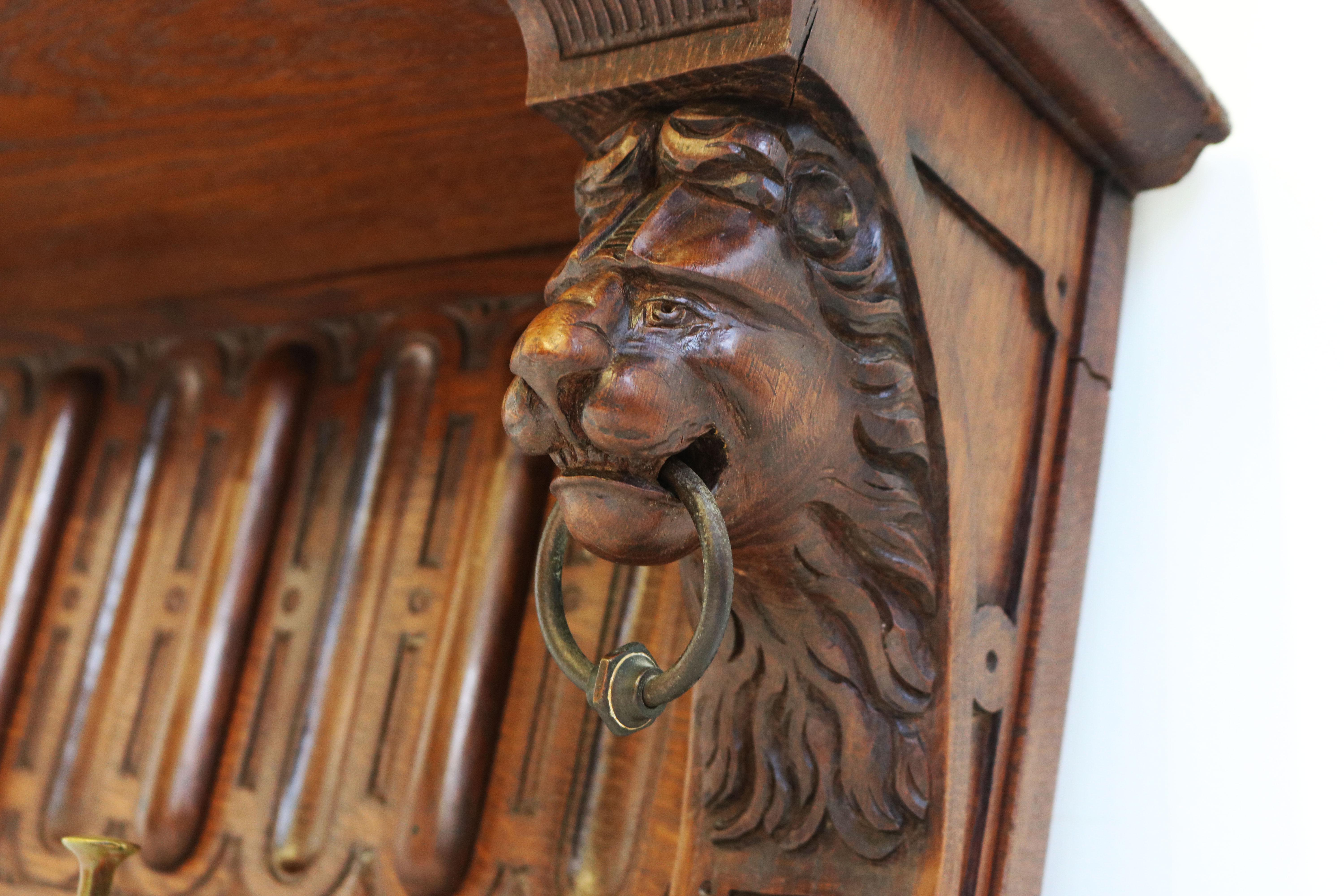 Large & most rare! This Renaissance revival coat/hat rack made from carved oak with Lion masks and original bronze hooks. 
Straight out of a French mansion, impressive size and quality. The lion masks are exceptionally carved with attention to