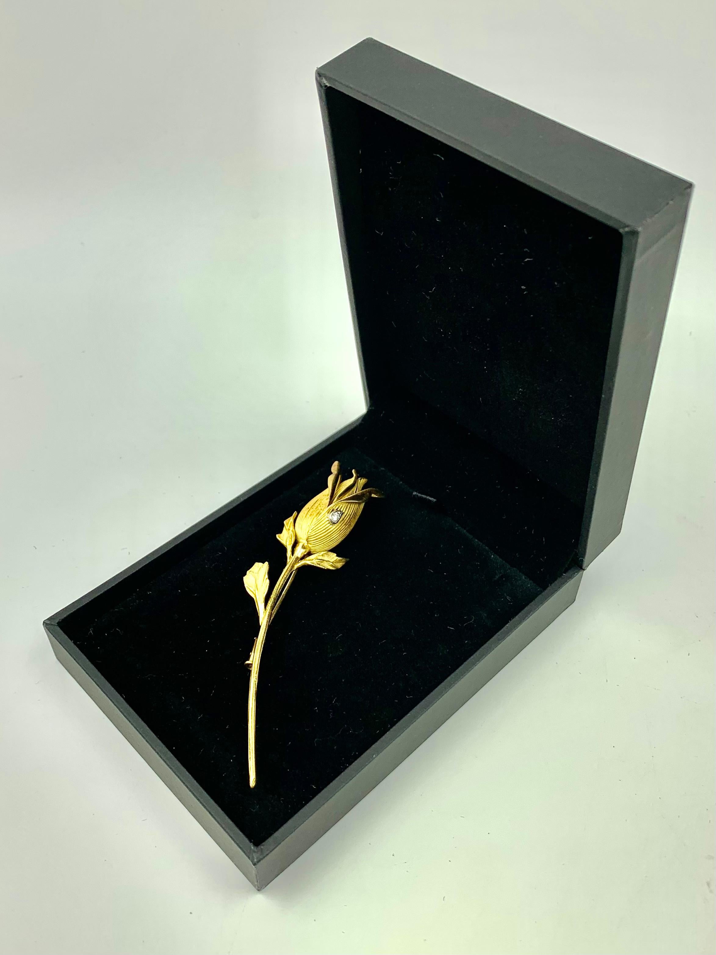 Romantic Eternal Rose 18k yellow gold brooch with a diamond dew drop accent by Rene Kern, Paris.
Naturalistically modelled with fine detail textured, matte and polished finish.
Large scale measuring 3.25 inches in length.
The earliest roses date to