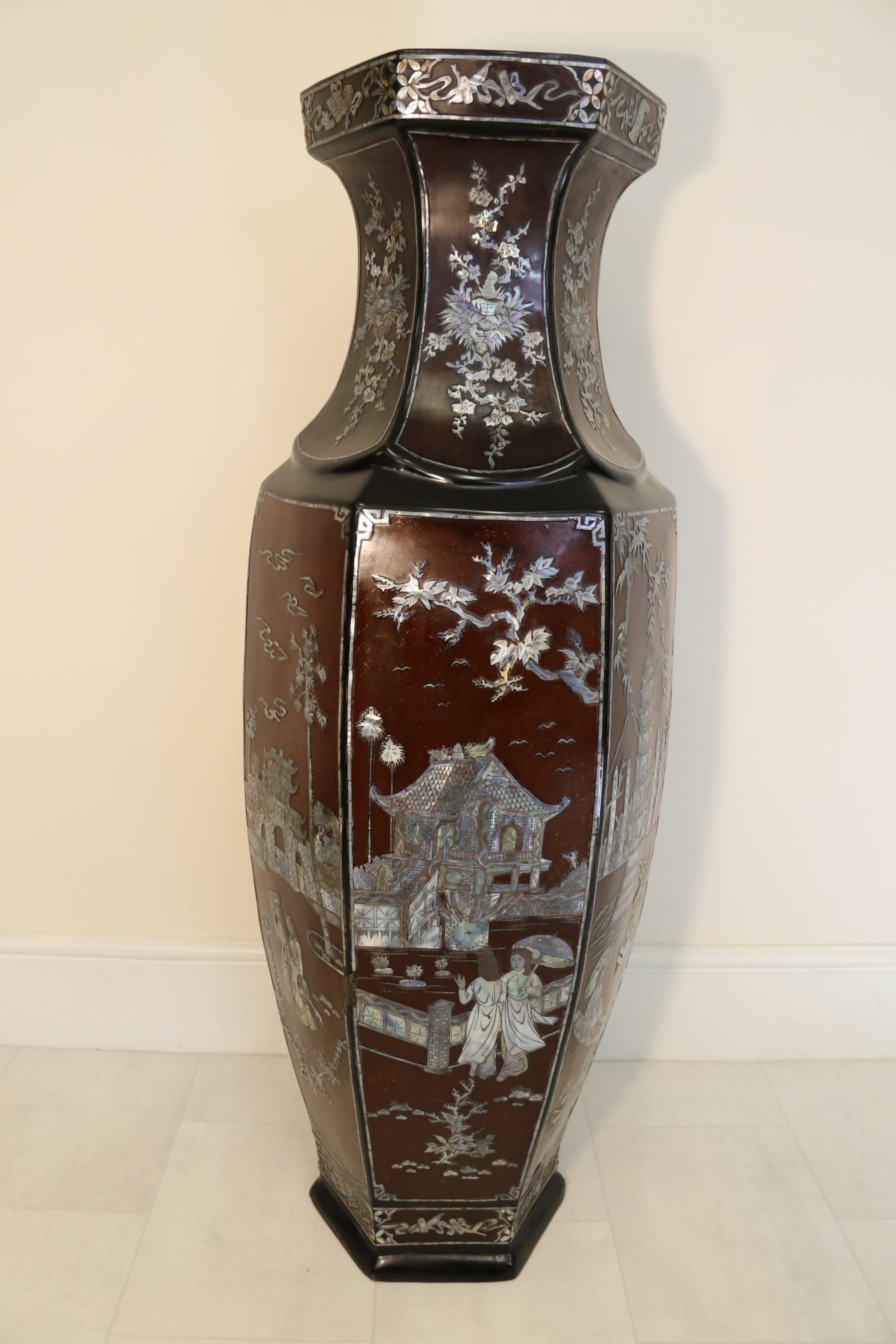 This remarkable Chinese lacquer vase dates to the Republican period, circa 1930.

It is made from papier-mache with a black ground with panels of brown lacquer inlaid throughout with cut and engraved mother of pearl.

The vase is of hexagonal