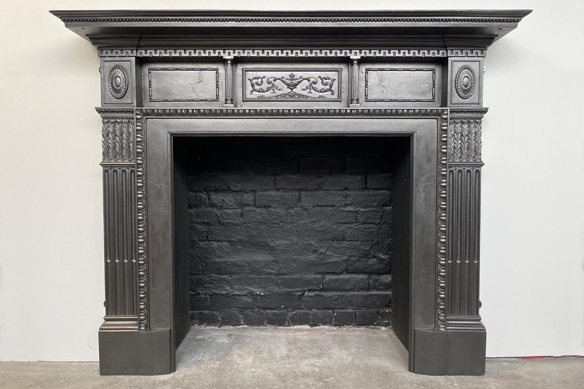 Large restored Victorian cast iron fireplace surround with Corinthian pilasters terminating in rosette capitals, the under shelf is supported by a pair of small pillars and centred in a finely cast tablet. The aperture is framed with egg and dart