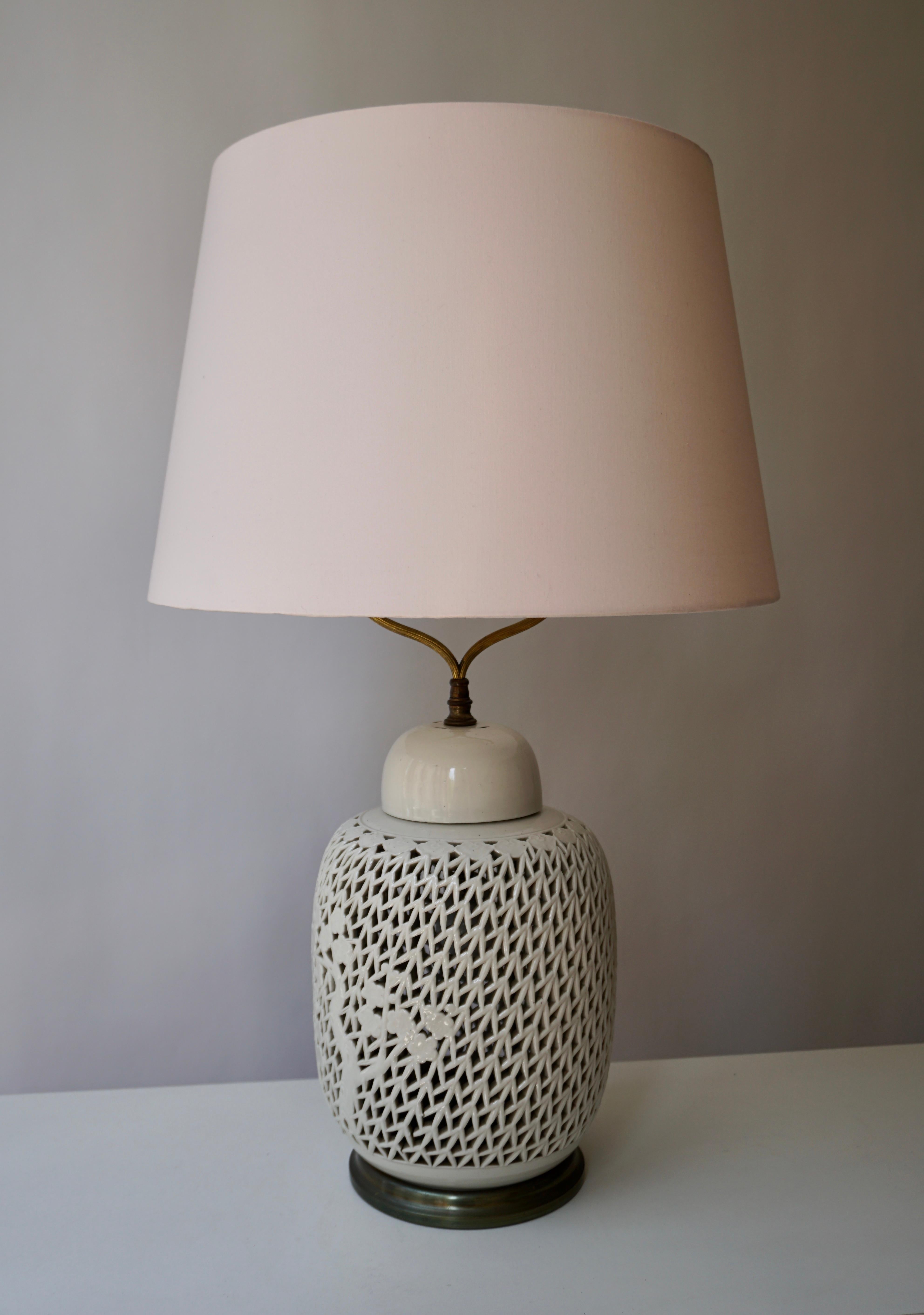 Unusually large scale reticulated Blanc De Chine porcelain table lamp. This example has an interior light allowing illumination from the upper bulb and or the interior light as illustrated in the pictures. The lamp is in very good, original and