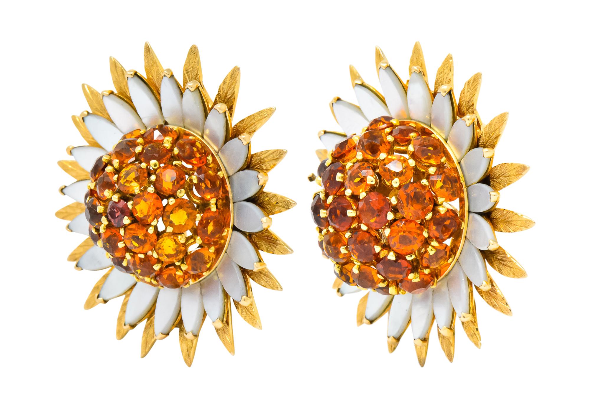 Each clip designed as sunflower with two layers, outer layer as stippled gold leaves and inner layer as white mother-of-pearl petals

Domed center of sunflower is comprised of round cut citrine, ranging from orangey-yellow to reddish-orange in