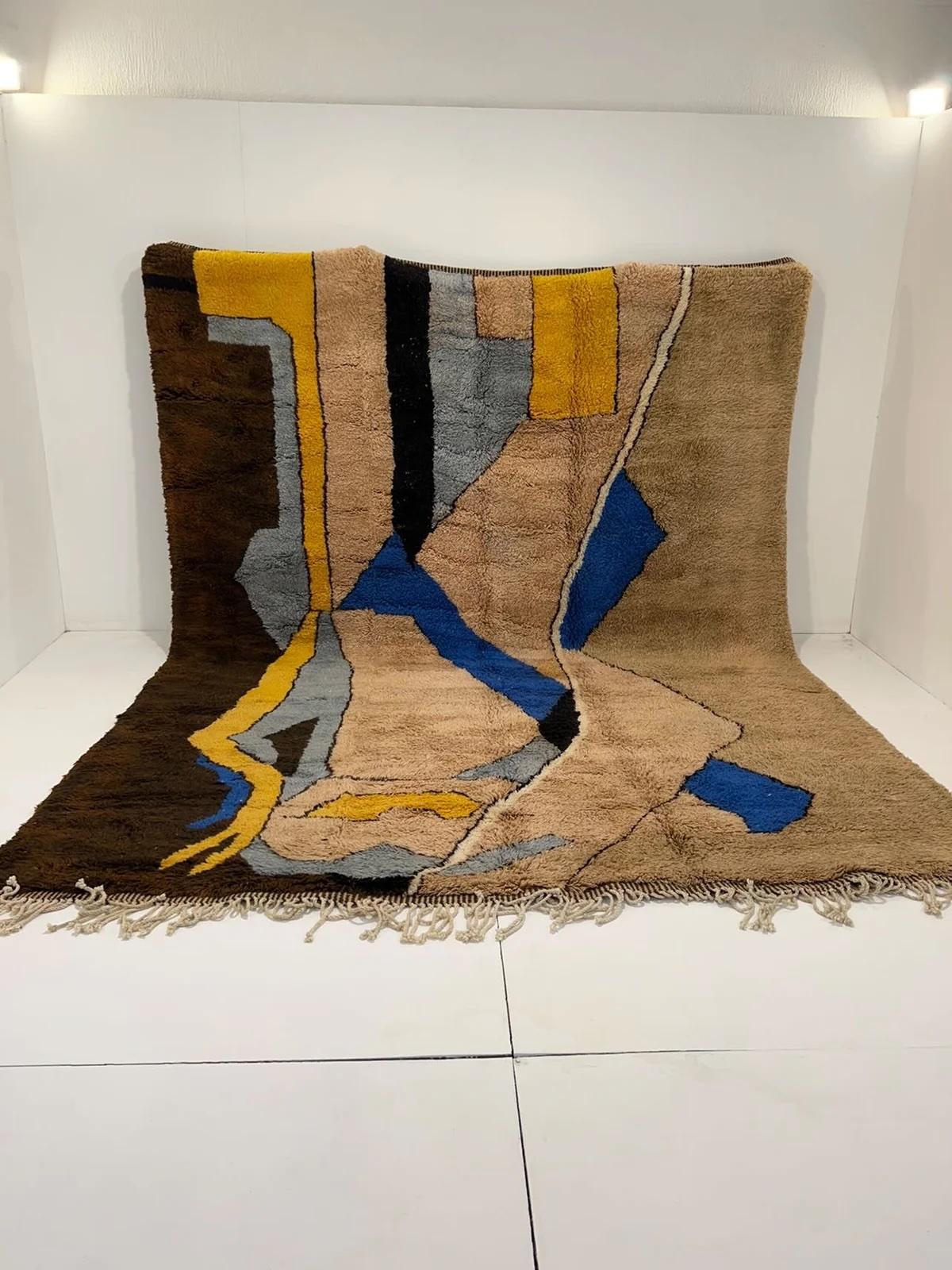 This large, funky handwoven Moroccan rug was made by hand by skilled artisans in the Atlas Mountains using the highest quality M'Rirt wool. It is impressive in both size and design, and is the perfect luxury statement piece for any room. The design