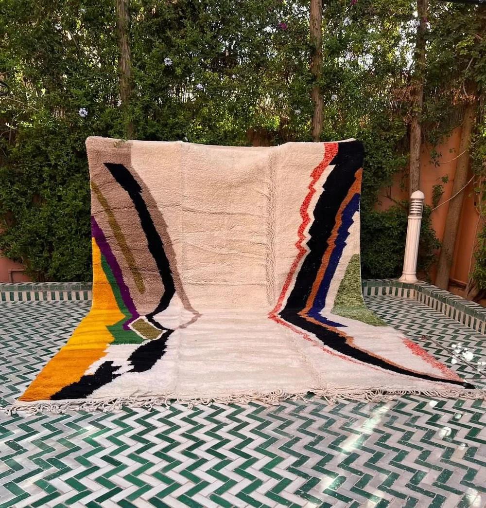 This large, funky handwoven Moroccan rug was made by hand by skilled artisans in the Atlas Mountains using the highest quality M'Rirt wool. It is impressive in both size and design, and is the perfect luxury statement piece for any room. The design