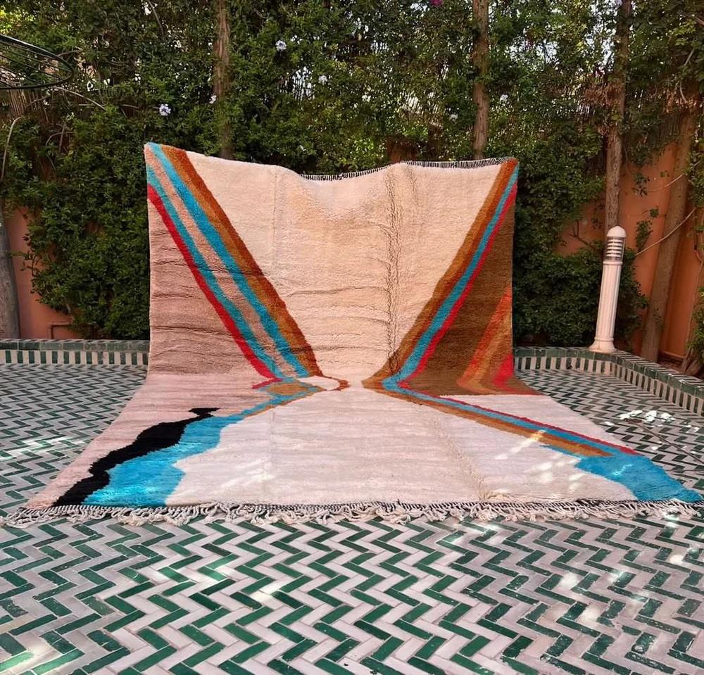 This large, funky handwoven Moroccan rug was made by hand by skilled artisans in the Atlas Mountains using the highest quality M'Rirt wool. It is impressive in both size and design, and is the perfect luxury statement piece for any room. The design