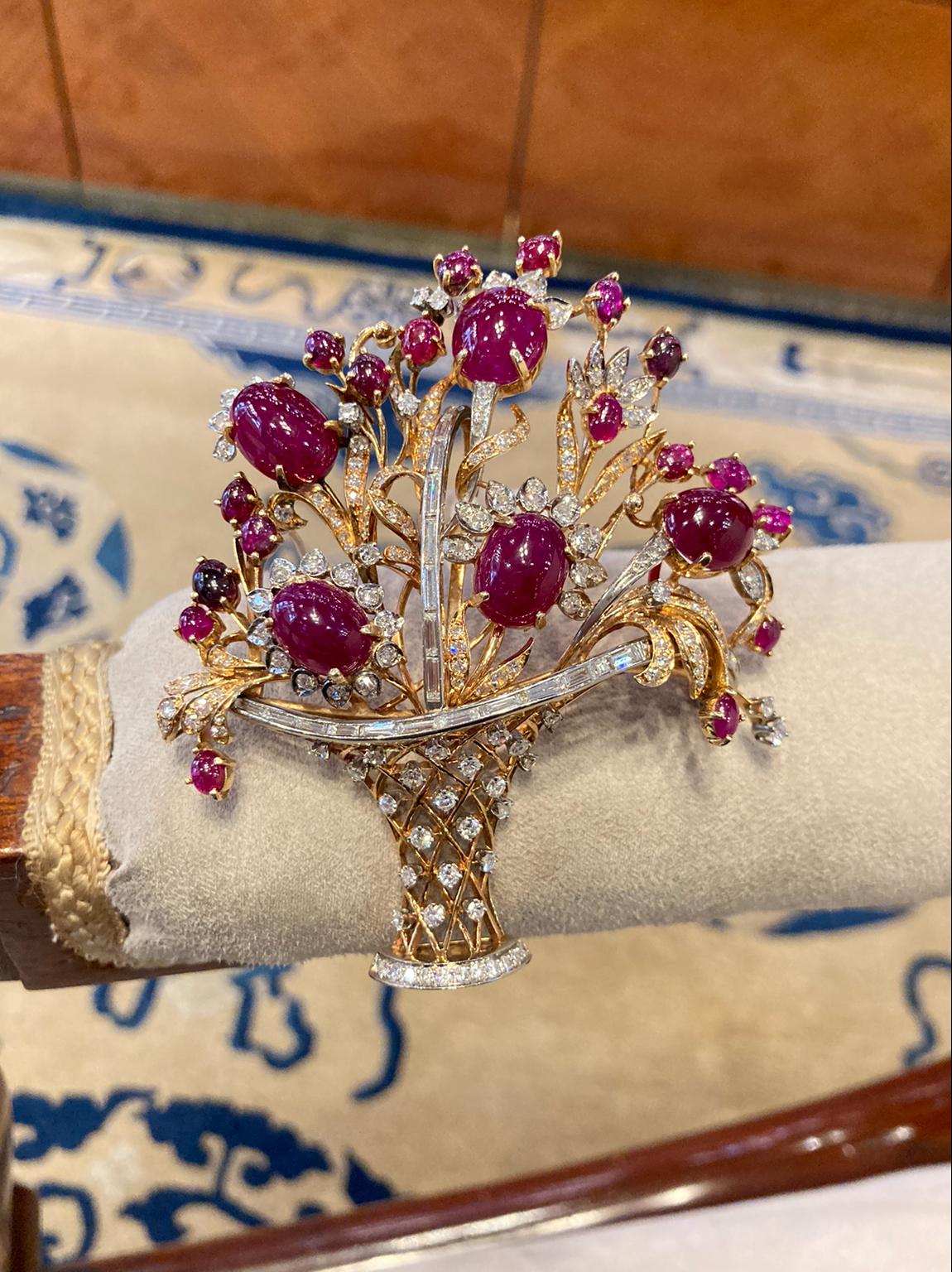 An exquisite giardinetti flower basket statement brooch embellished with natural cabochon rubies and diamonds, mounted in yellow gold. Circa 1940.