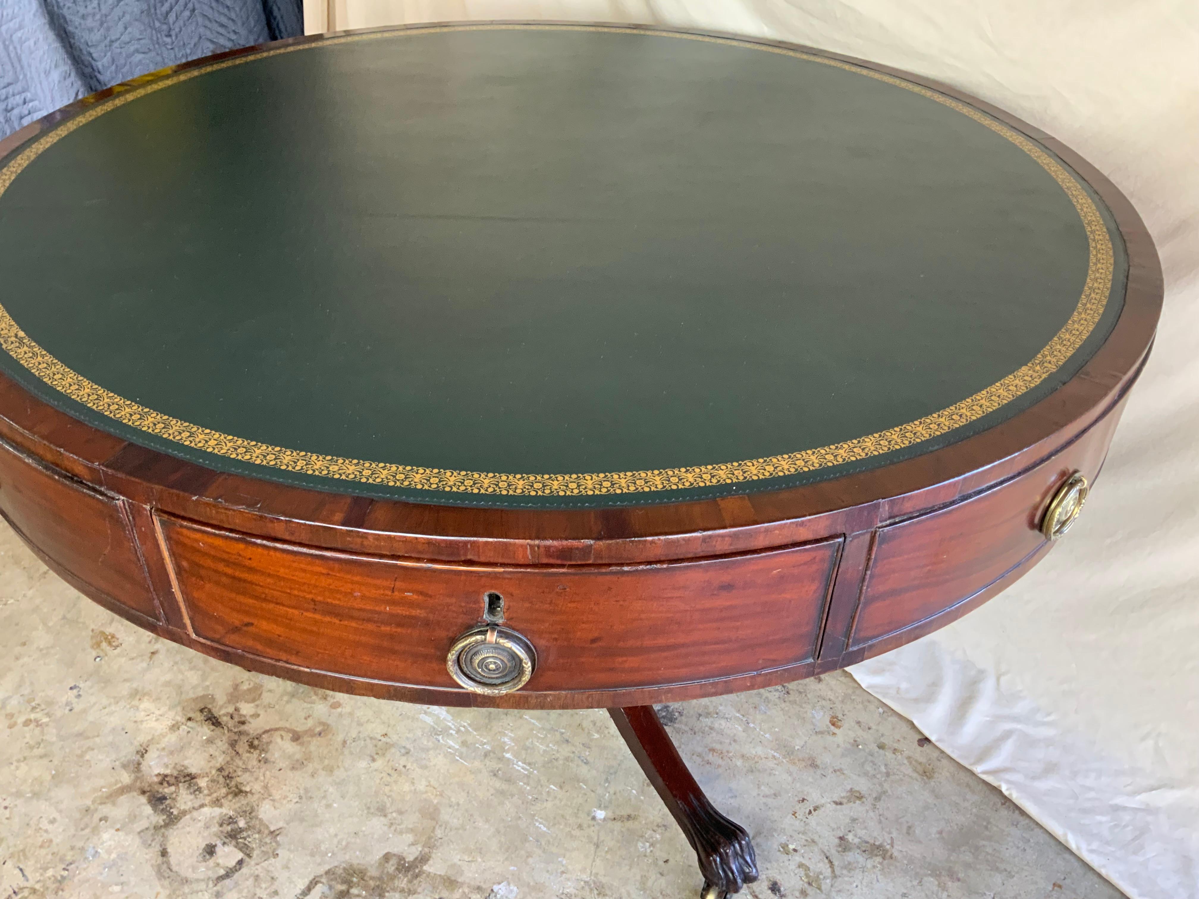 A attractive large early single pedestal Victorian Mahogany revolving Drum Table with a newer gold tooled leather top.  Nice original finish with a great color and patina to the aged surface.  There is a metal revolving mechanism attached to the