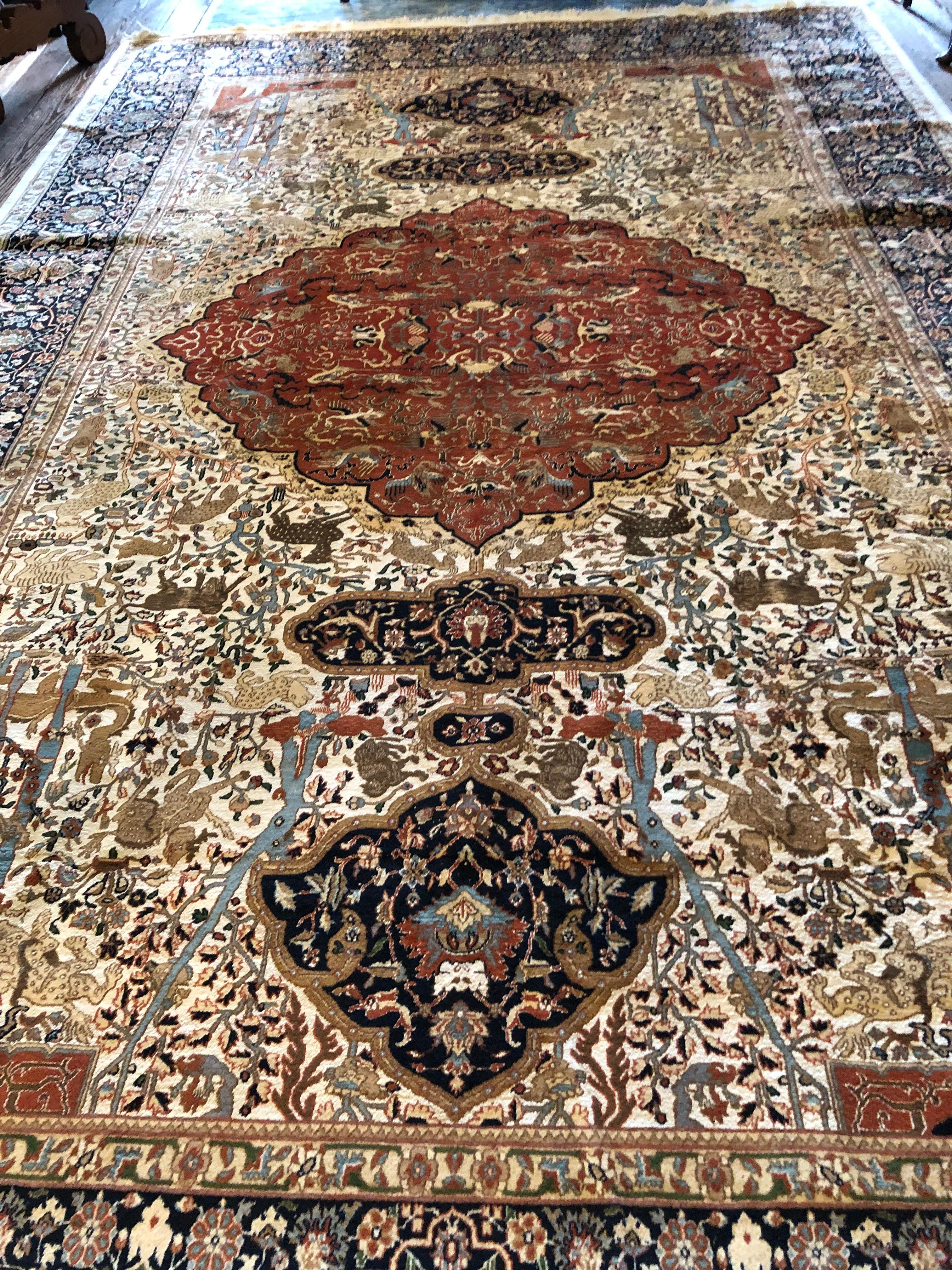 Rich pattern and coloration in a large imported wool rug having geometric shapes as well as whimsical animals in the design.  Color palette has many earth tones as well as navy and powder blue and cream.

(Sorensen)