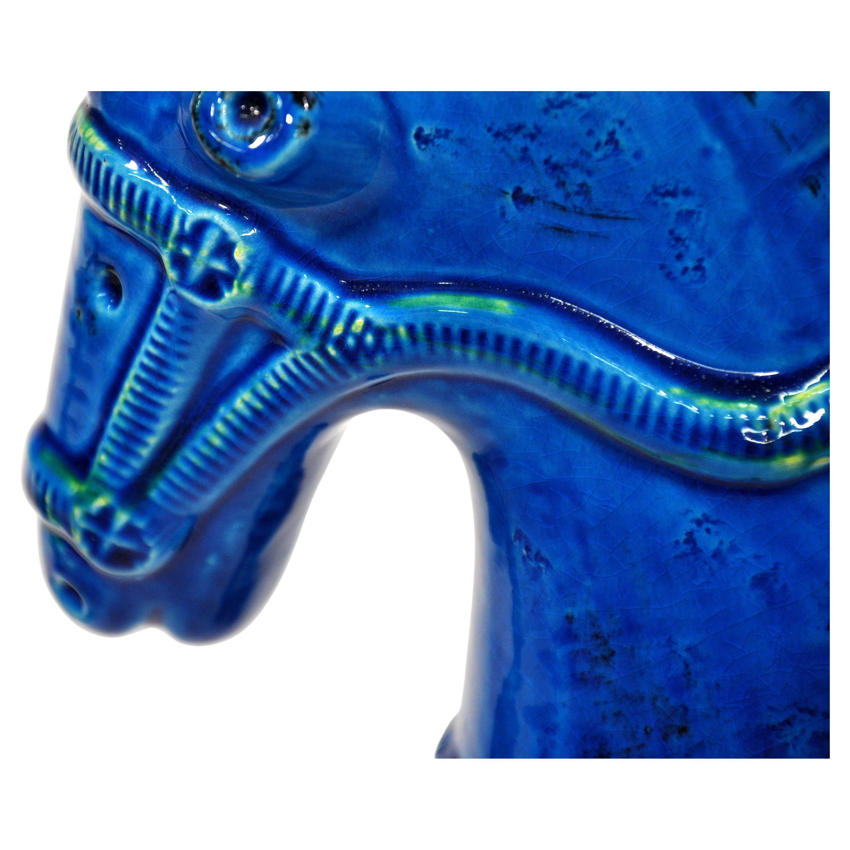 Imposing pair of Italian handmade ceramic horse sculptures in the vibrant signature blue of Aldo Londi's iconic art pottery collection Rimini Blu, originally designed in 1959 for Bitossi Ceramiche and imported by Raymor in the 1960s. The deep blue
