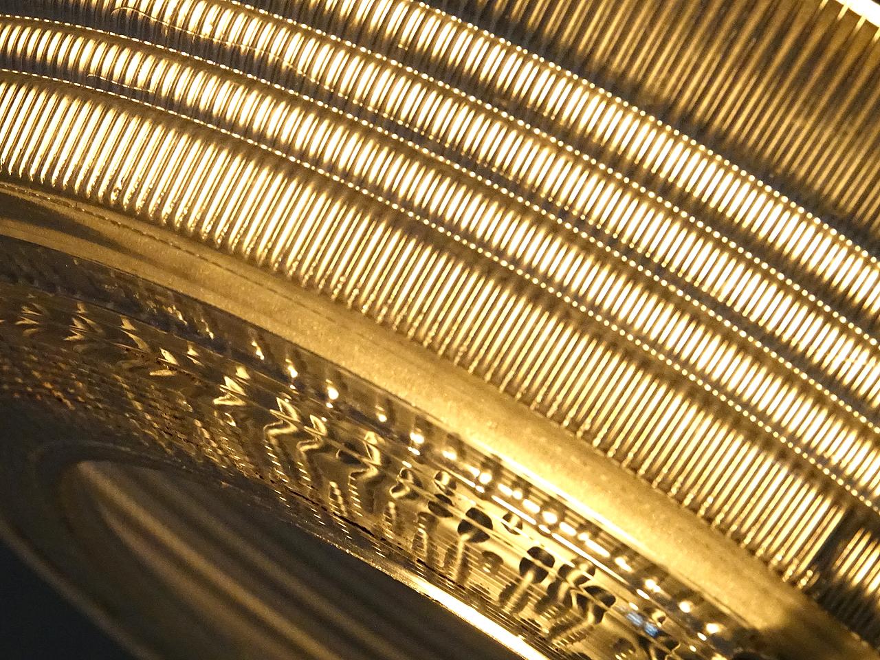 This is an impressive and elegant hanging lamp. The complex prismatic glass was manufactured by The Holophane Company. The look of their glass is very unique and always takes on a warm pleasing glow.