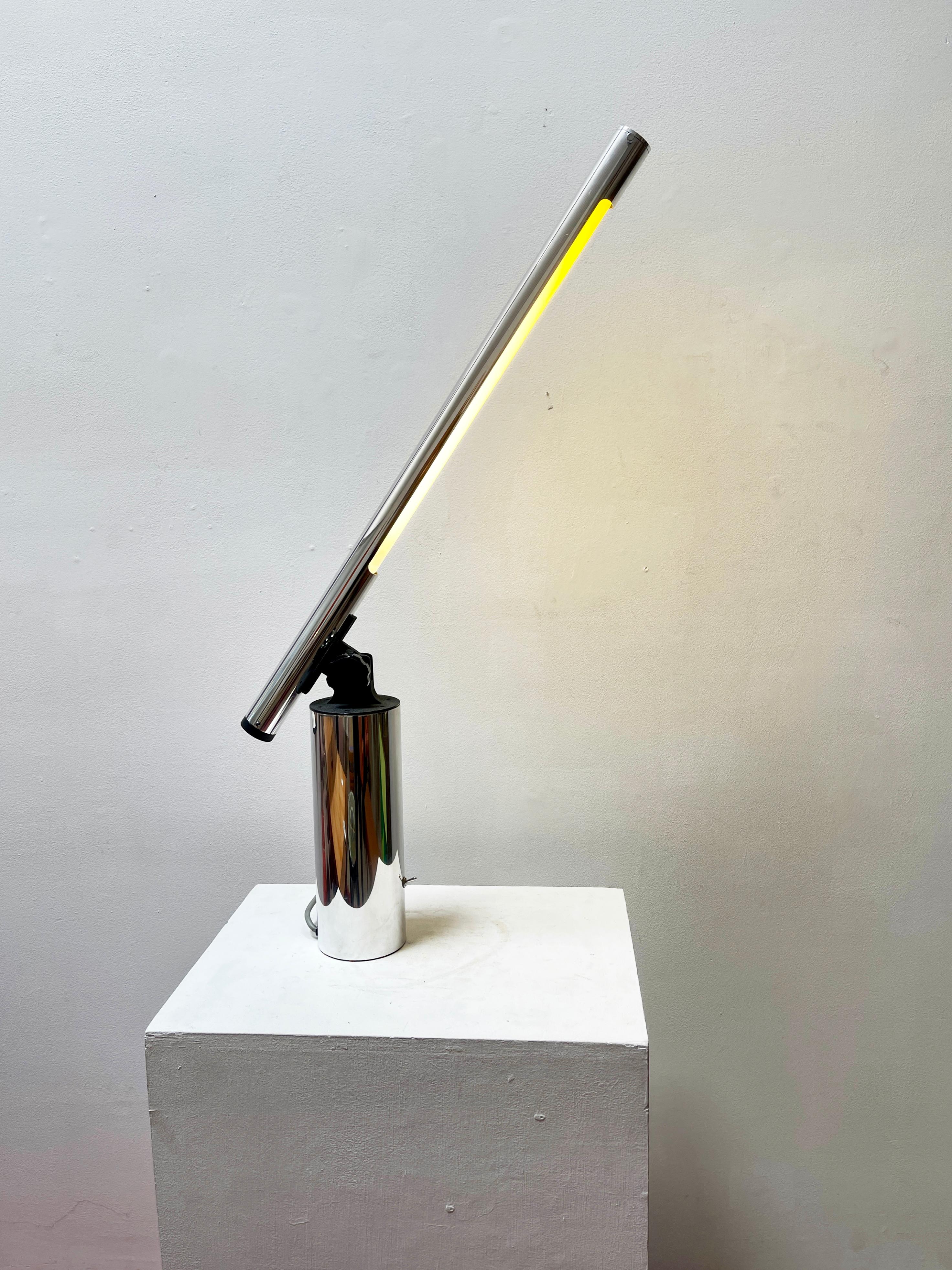 Robert Sonneman designed modern table lamp from the 1970s. Polished aluminum. Fluorescent tube, casts a white light - not yellow. Fully adjustable, ranges in height from 18in to 37in. Exciting in every position. Switch is located on the base.
