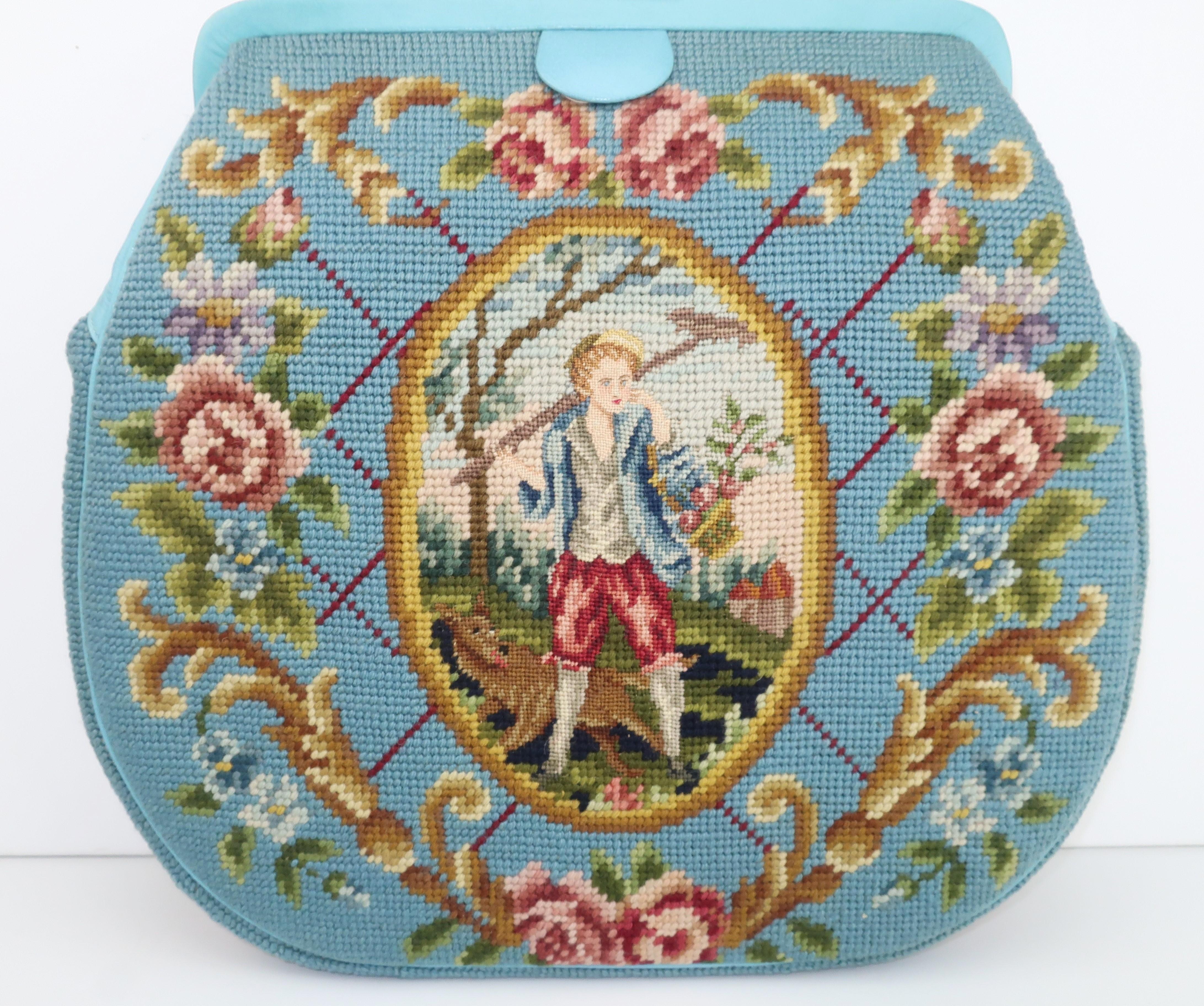 Not all 'granny bags' are created equal!  This 1950's needlepoint example is at the front of the pack with a robin's egg blue body accented by a country French scene depicting a petit point girl on one side and a boy on the other in shades of lilac,