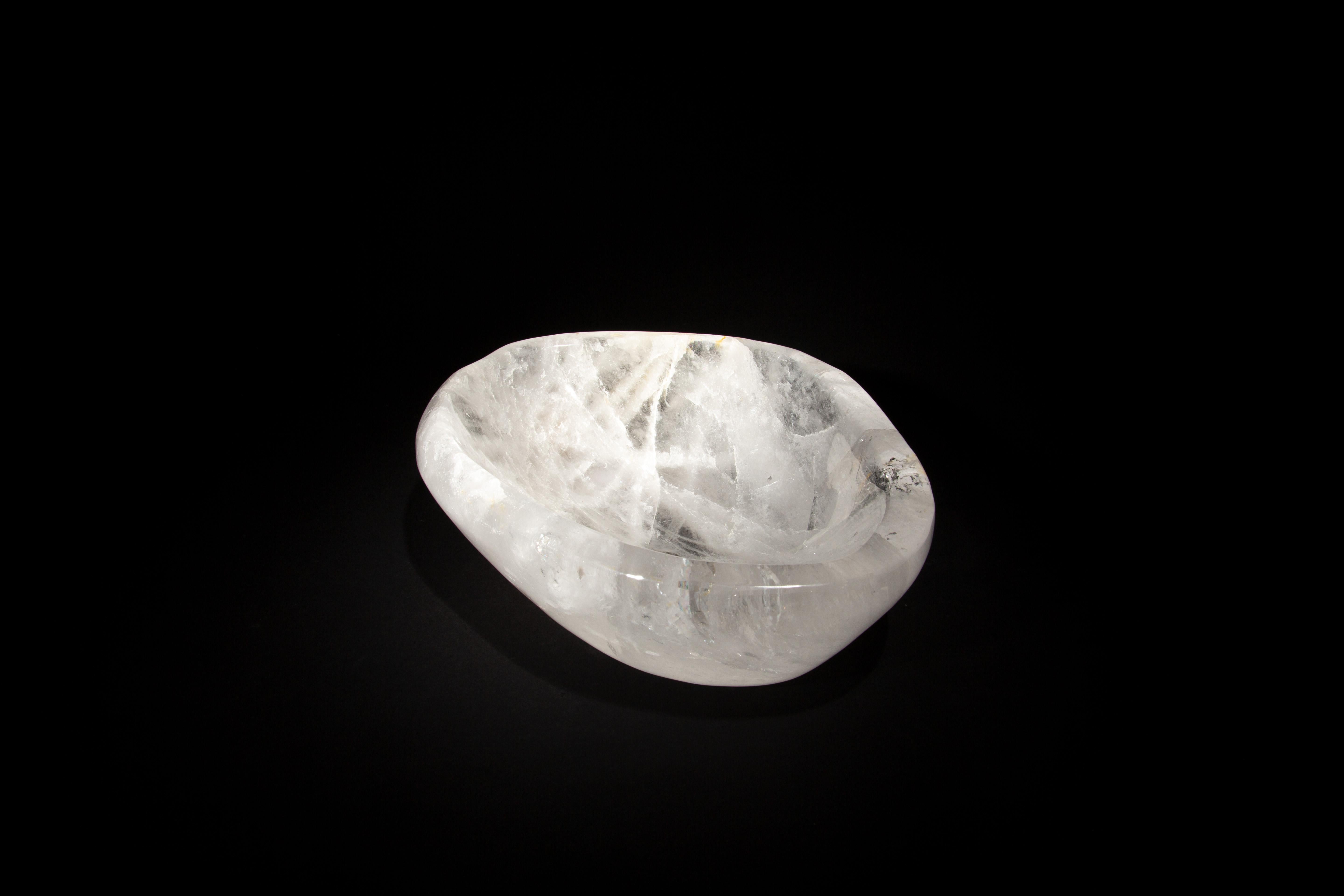 This Rock Crystal Bowl is a masterpiece of natural beauty and exquisite craftsmanship. Measuring 10.5 inches by 8.25 inches with a height of 3 inches, it is meticulously sculpted from pure rock crystal, known for its transparent allure and icy