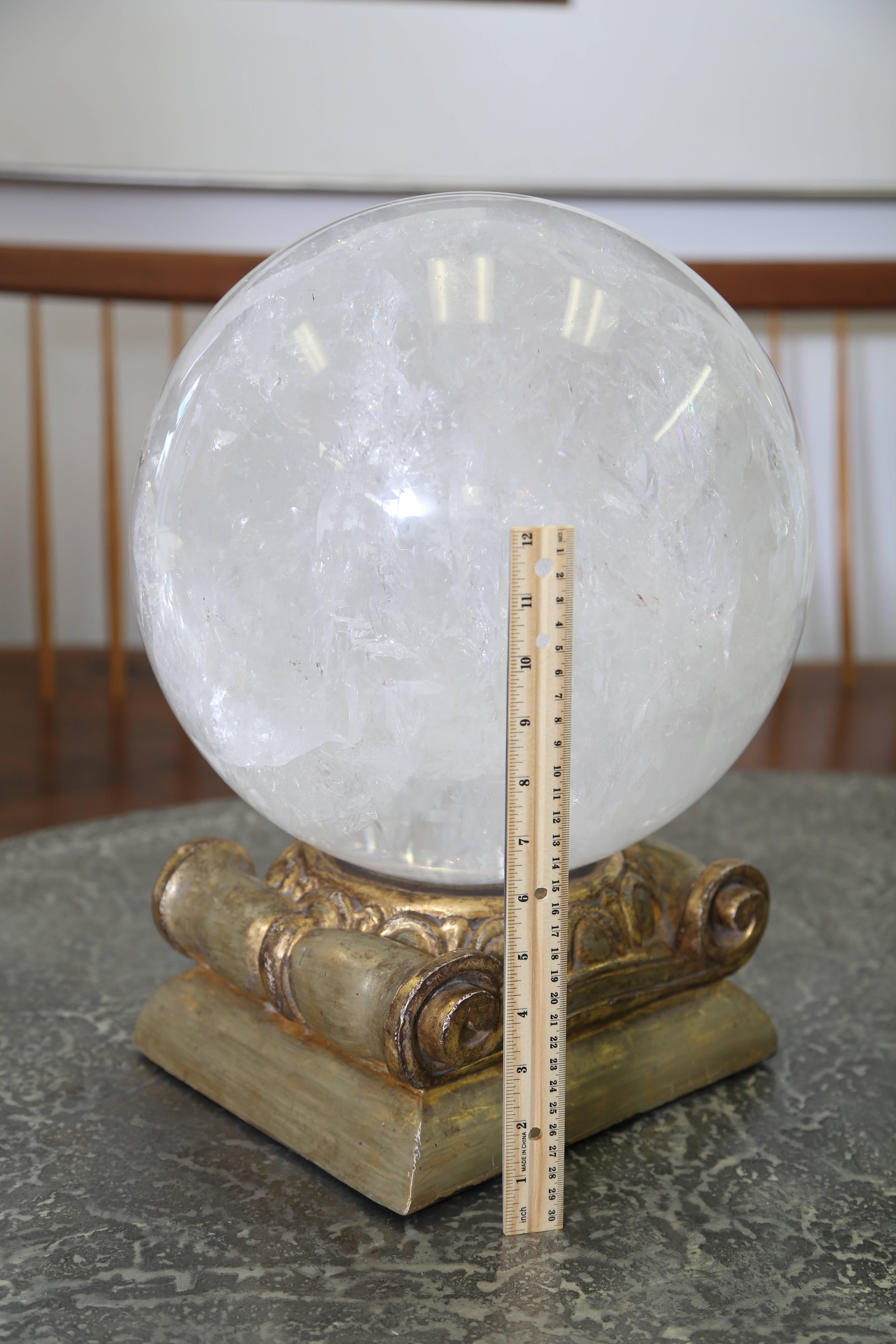 A vintage carved rock crystal orb on a gold-leafed column base.
A spectacular example.
 
 