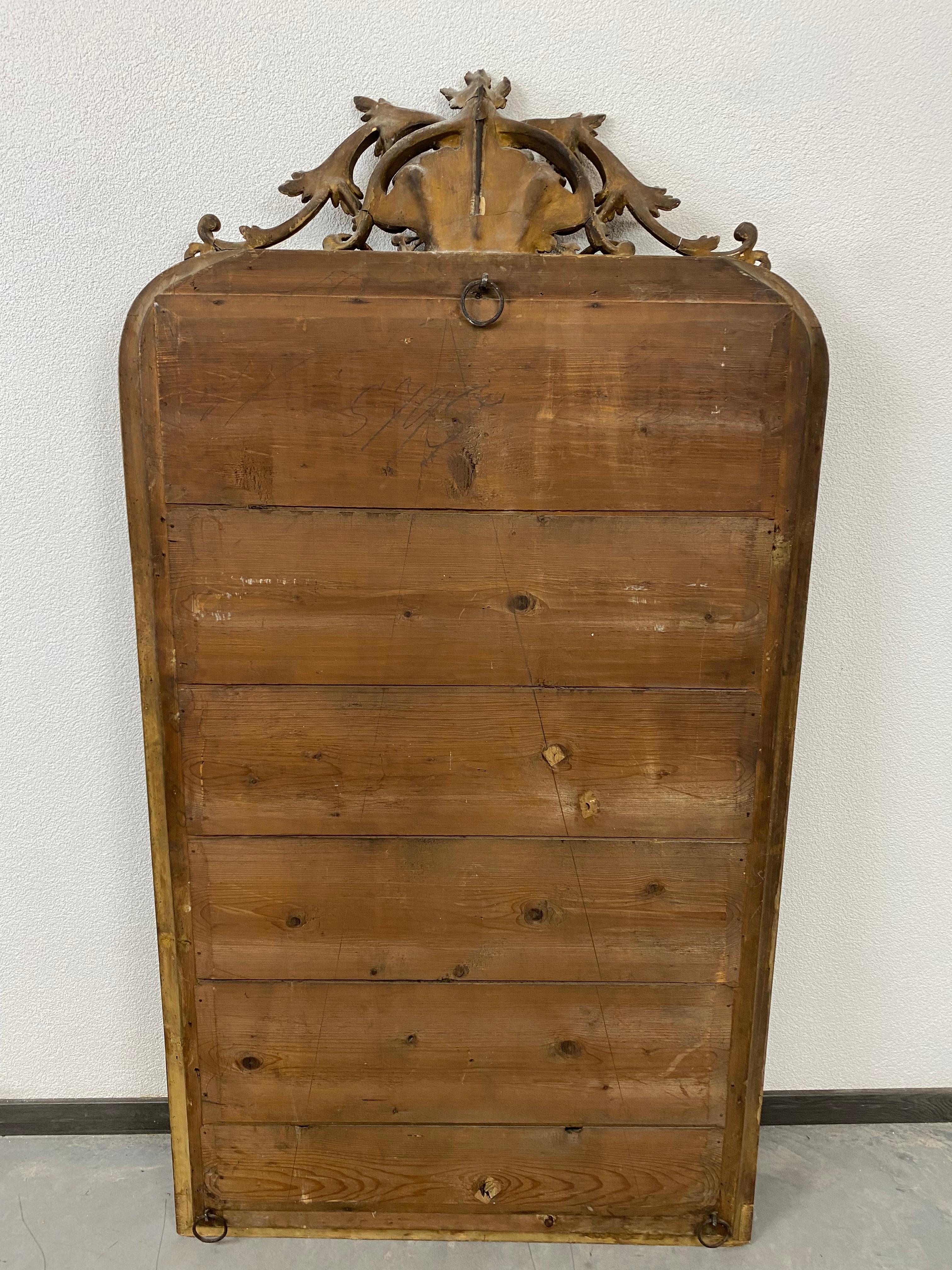 Large Rococo style wall mirror circa 1850 in original condition with signs of usage.
