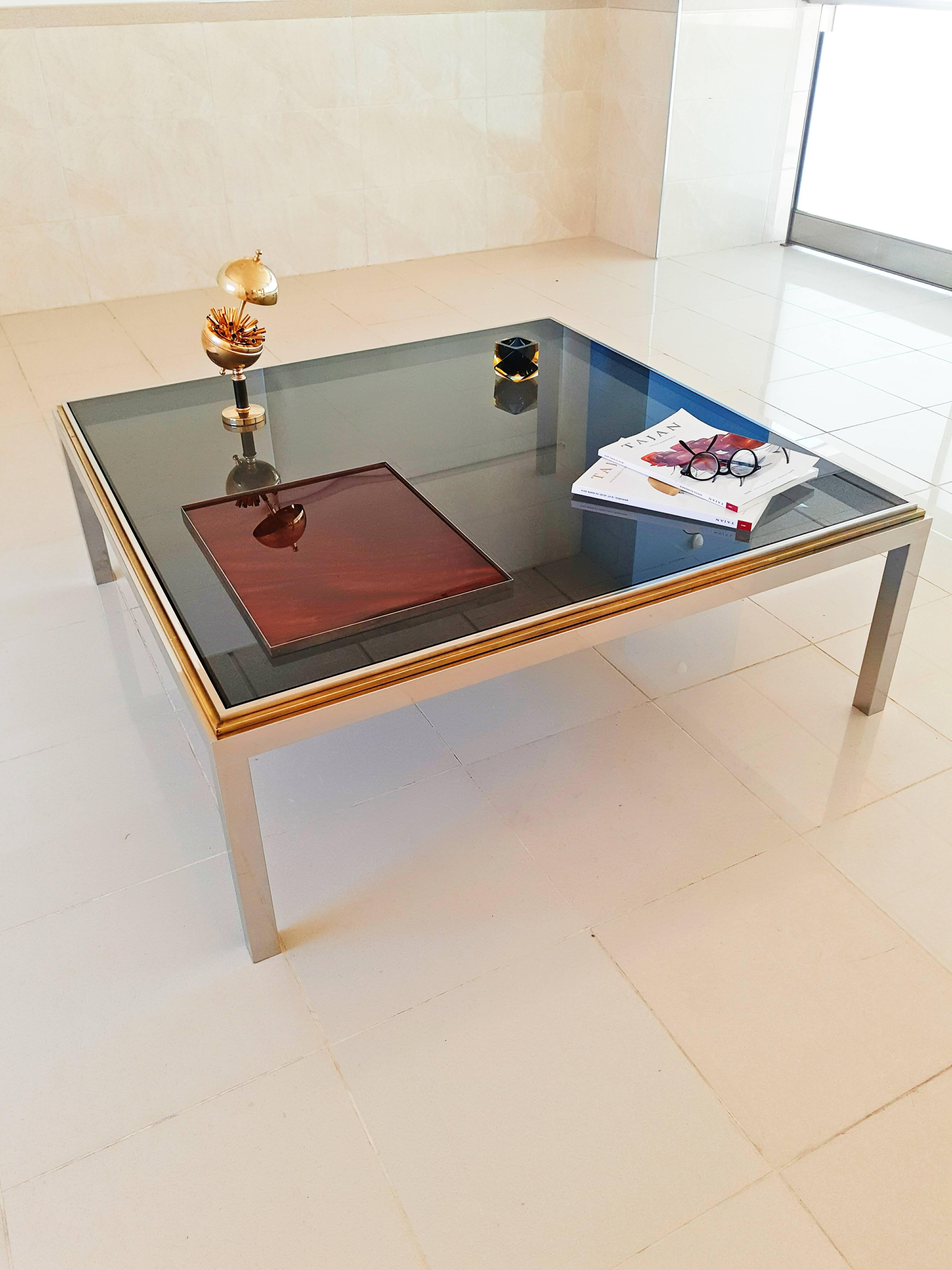 Beautiful and rare very large Romeo Rega coffee table in chrome, brass and smoked glass. In perfect vintage condition.