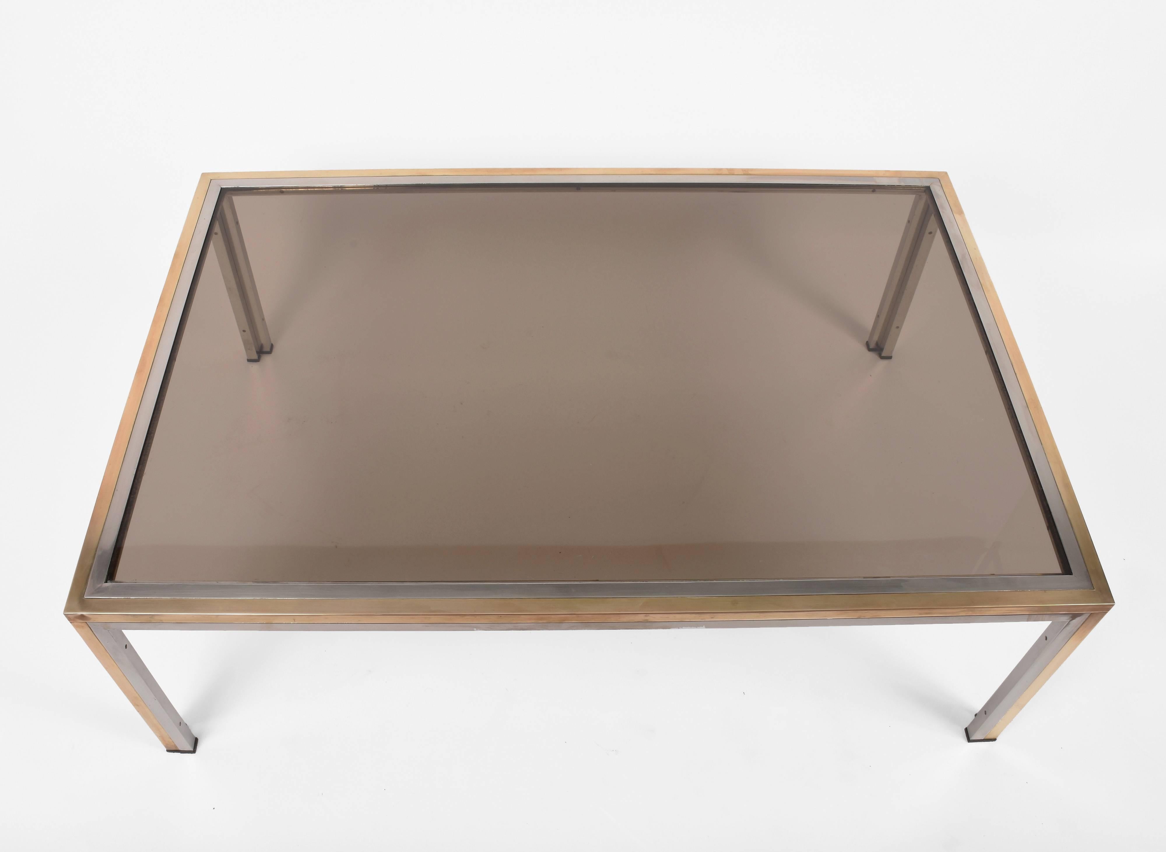 Elegant coffee table in chromed metal and brass, smoked glass adds to the seductive elegance of this midcentury piece.
Measurements: 120 x 80 H 40.