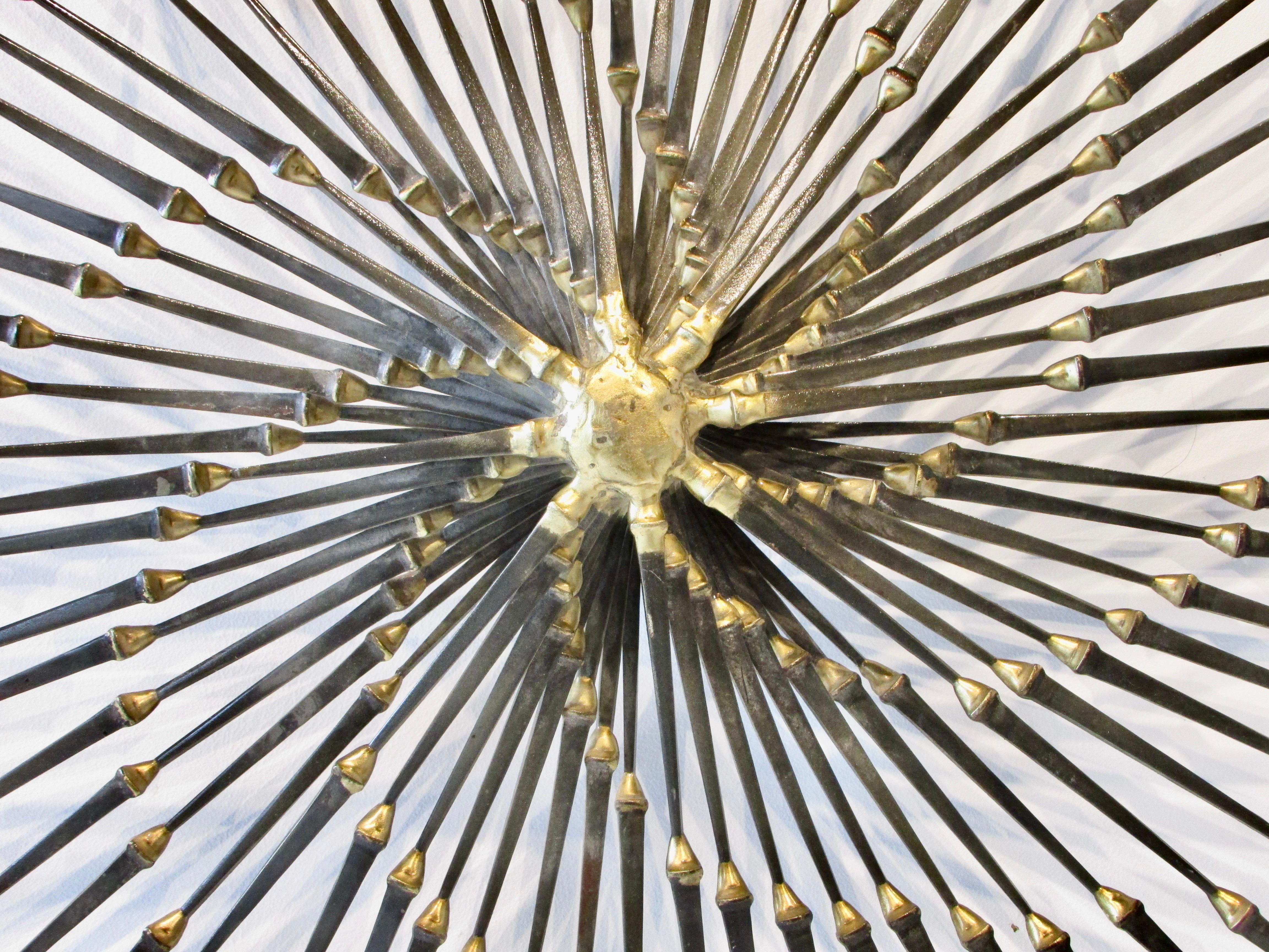 Individual steel spikes brazed together in a large fanned out pattern. Assembled by Ron Schmidt.