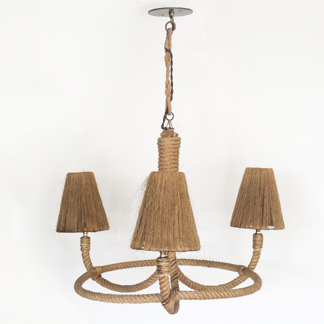 Beautiful large chandelier by Adrien Audoux and Frida Minet from France, 1950's. Circular frame with 3 curved arms and lights, all made of twisted rope. Original straw shades. Newly re-wired. Original rope and shades show sign of age and