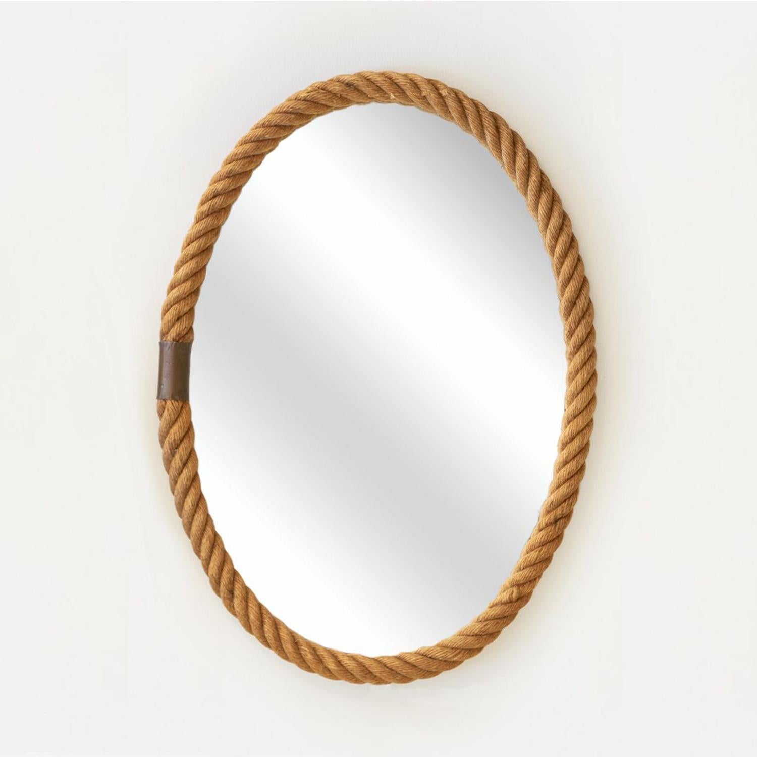 Stunning large scale oval wall mirror with thick twisted rope frame and brass detail. Original mirror in good vintage condition. By Adrien Audoux and Frida Minet from France, 1940's. Perfect for a primary bath or powder room. One available, sold