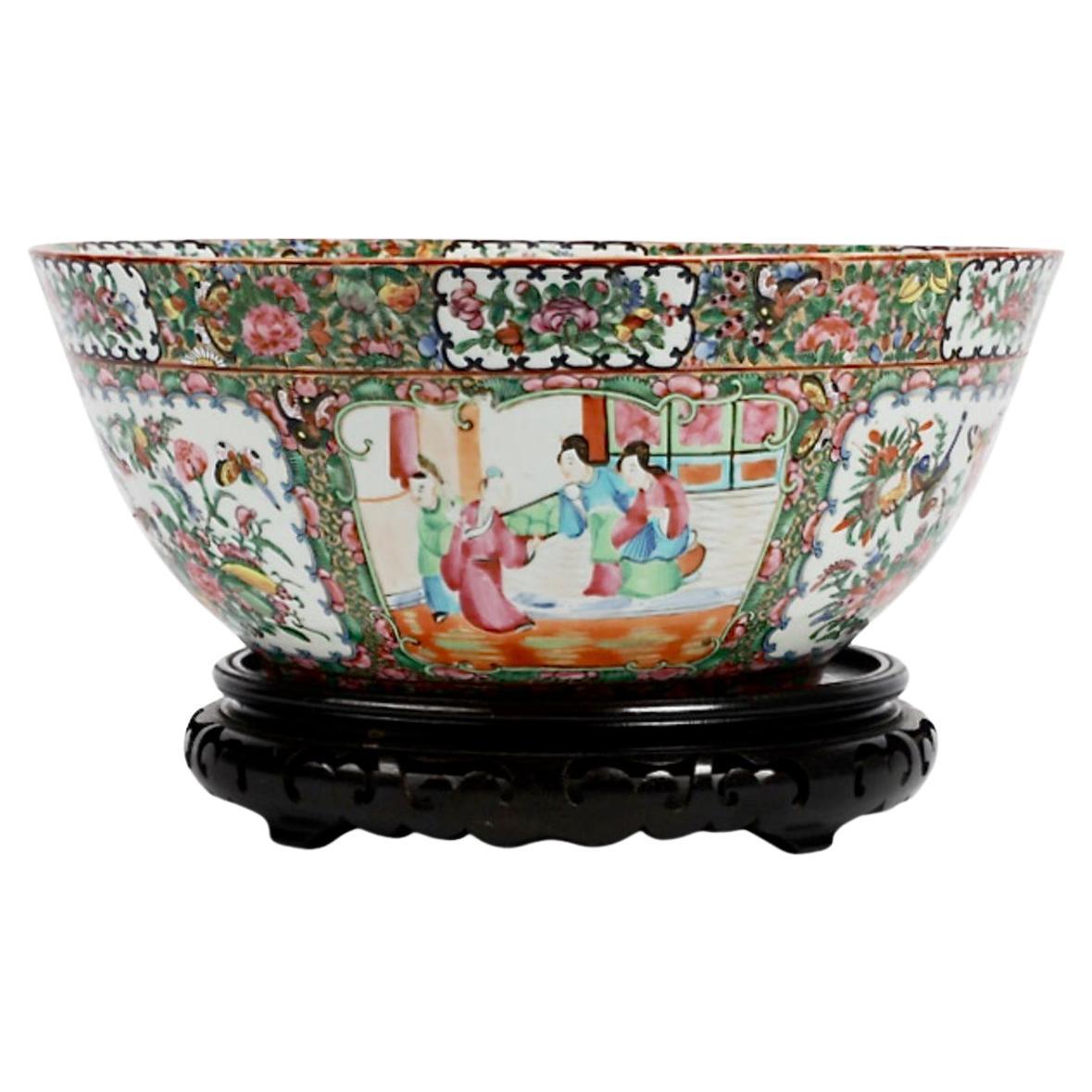 This is an excellent example of a large Chinese Export Famille Rose Punch Bowl in the Rose Mandarin pattern. The bowl is beautifully decorated with traditional Chinese figures and floral and bird reserves. The bowl is in overall very good condition