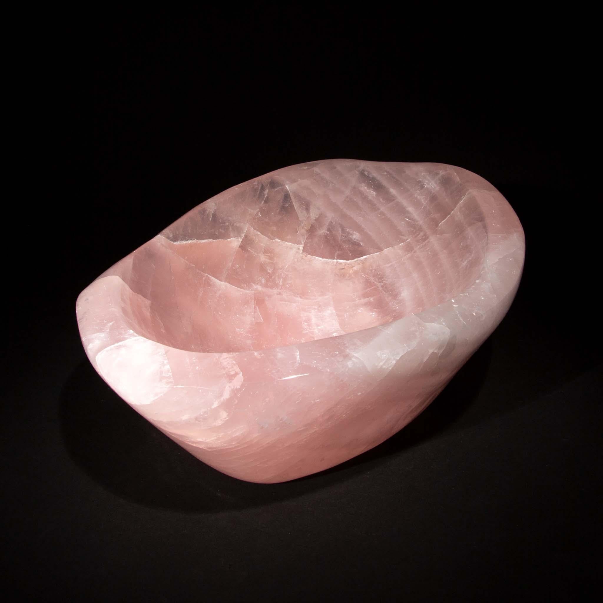 This Rose Quartz Bowl is a splendid showcase of soft elegance and refined artistry. With dimensions of 11.5 inches by 8.75 inches and a height of 4.25 inches, it is expertly carved from high-quality rose quartz, celebrated for its gentle pink tones