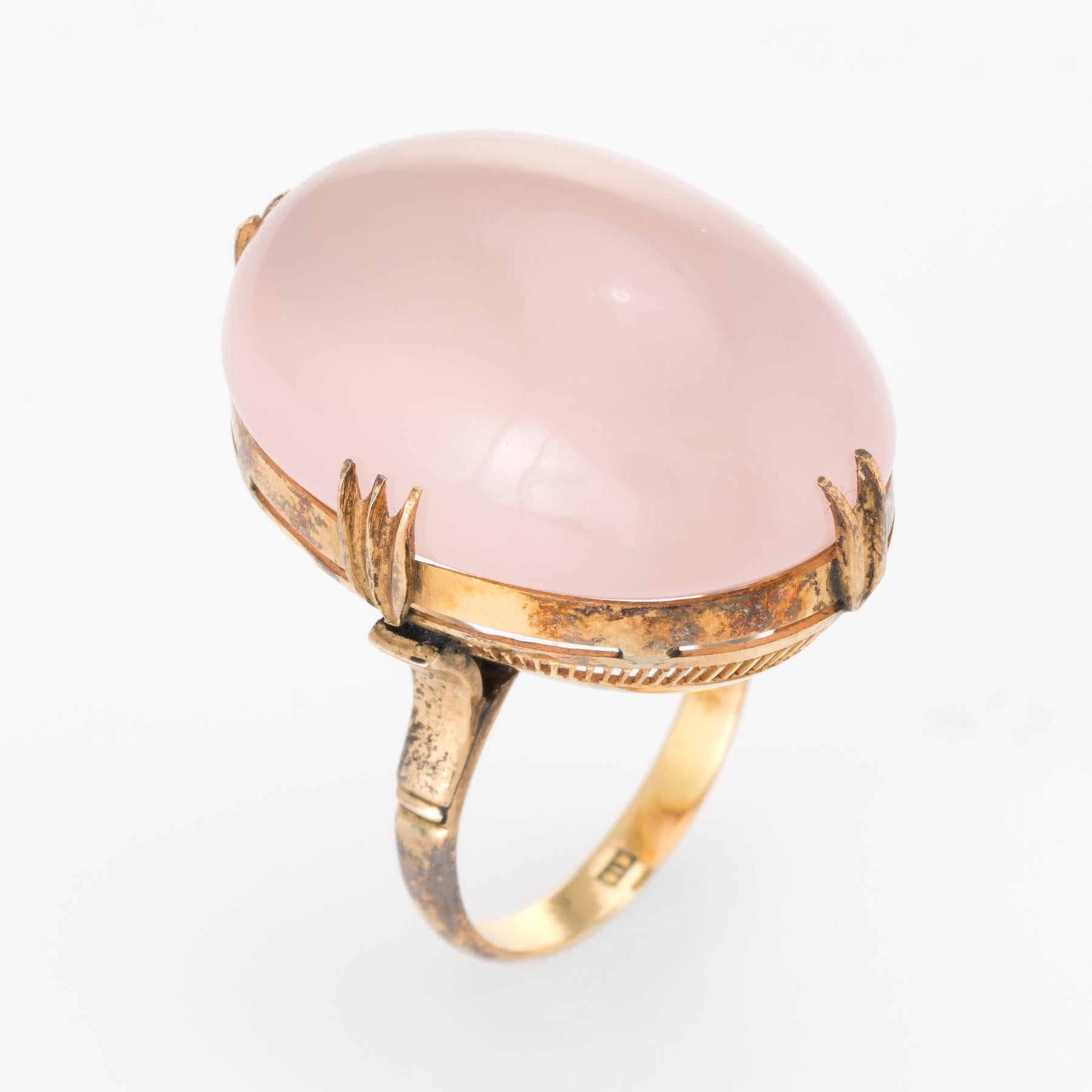 Elegant vintage cocktail ring (circa 1950s to 1960s), crafted in 18 karat yellow gold. 

Centrally mounted cabochon cut rose quartz measures 24mm x 18mm (estimated at 35 carats). The rose quartz is in excellent condition and free of cracks or chips.