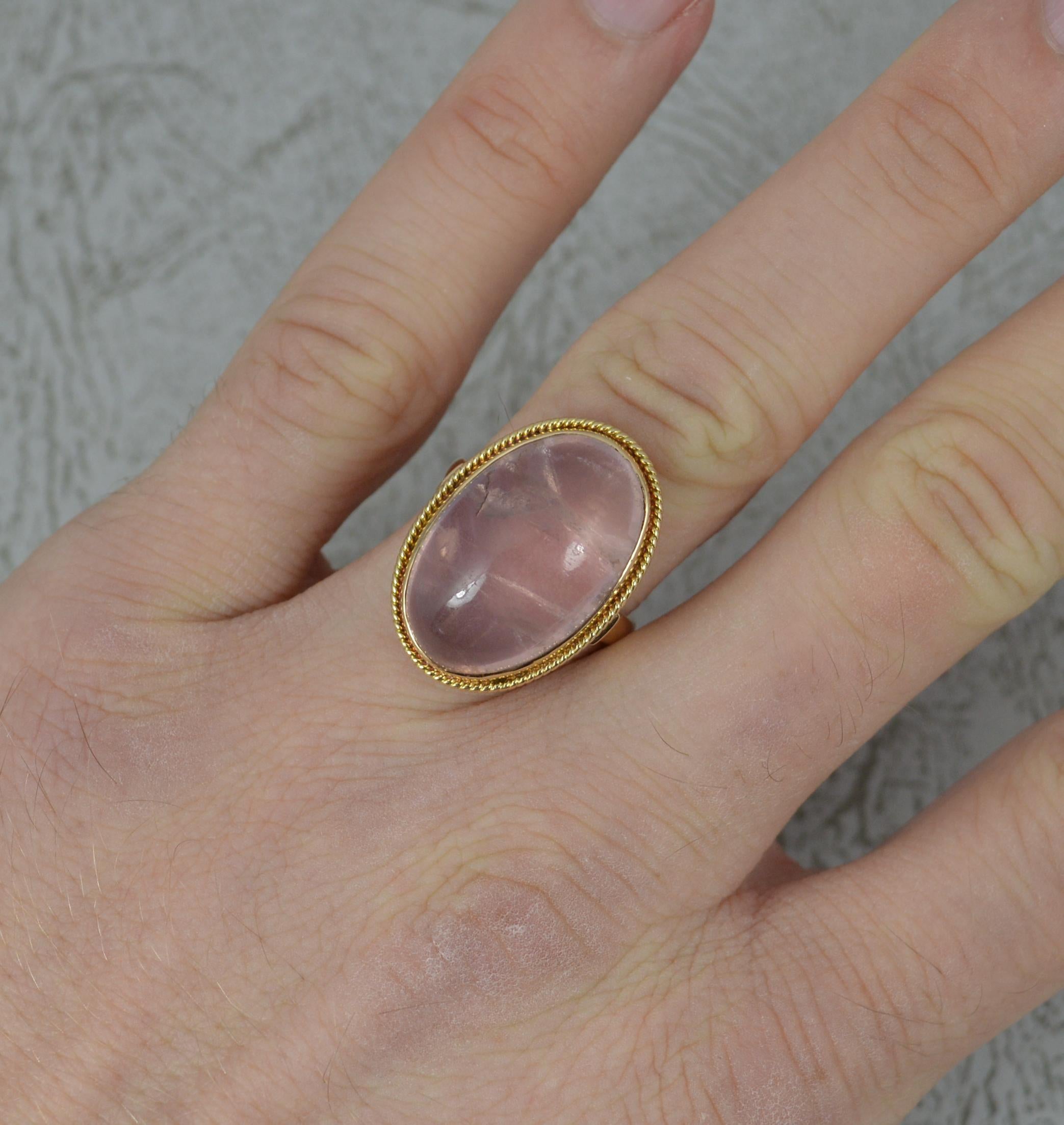 A beautiful ladies 14 carat gold and rose quartz ring.
20mm x 14mm rose quartz in bezel setting with a fine pierced cage.
Fine statement example.

Condition ; Excellent. Well set stone, some inclusions and a surface mark. Clean, strong, round band.