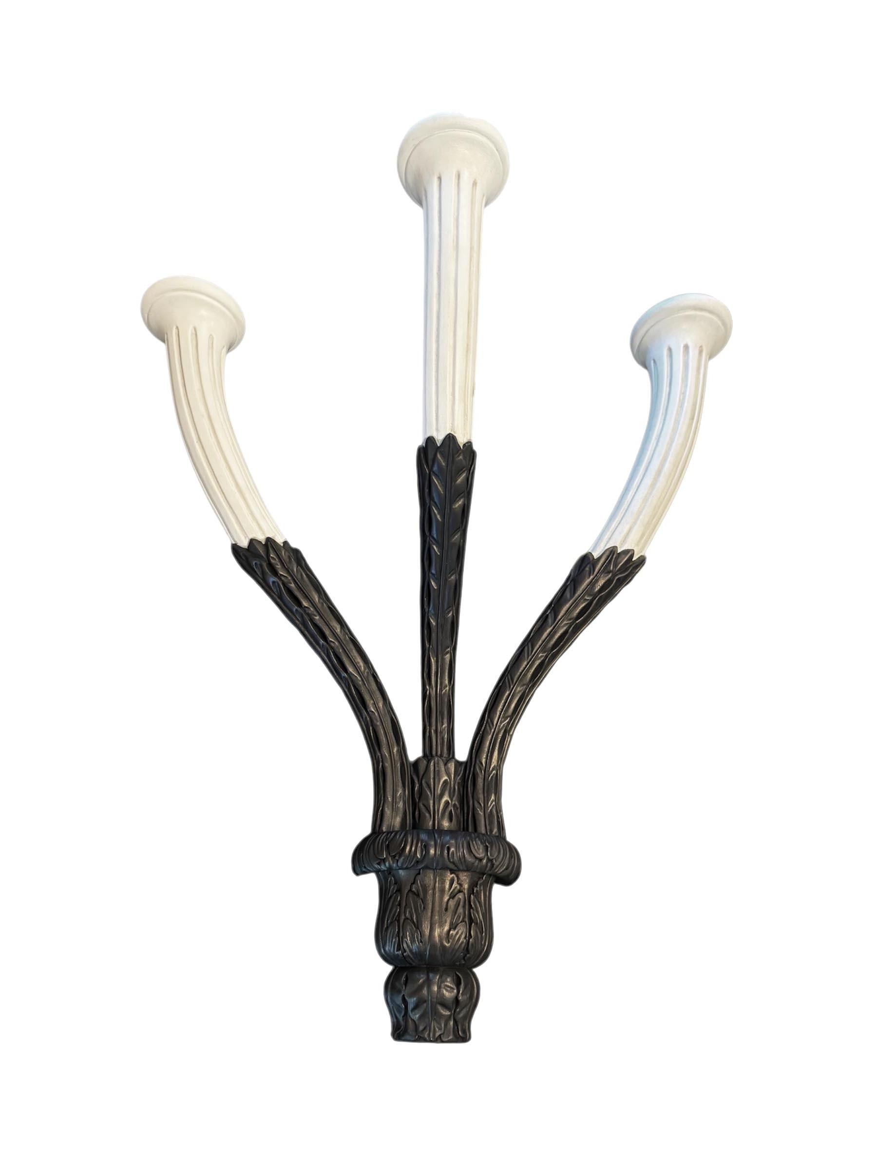 This stunning large three-arm candle sconce by Rose Tarlow is a striking blend of classical elegance and refined craftsmanship. Recently newly refinished with a custom two-tone paint and wax finish, the sconce features a rich contrast between its