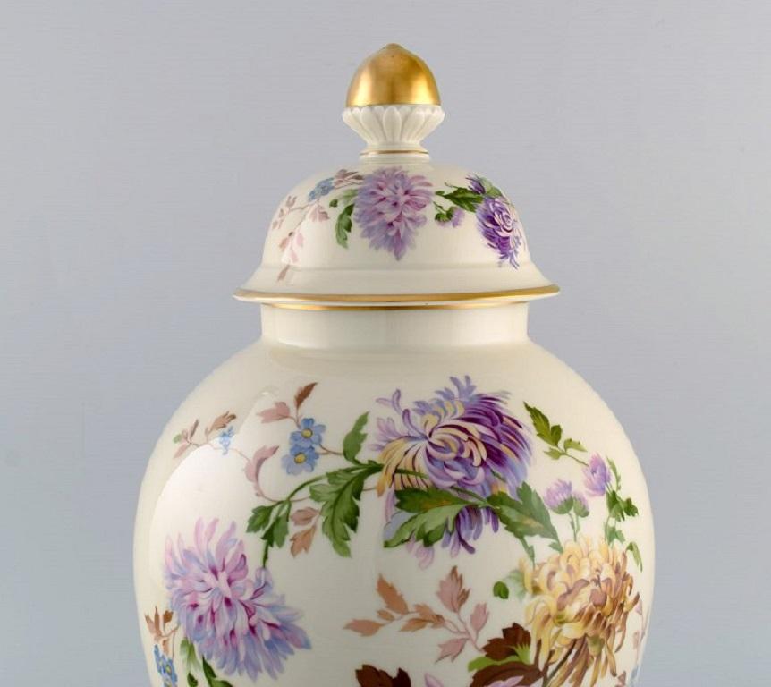 Large Rosenthal chrysanthemum lidded vase in cream-colored porcelain with hand-painted flowers and gold decoration. 
1930s.
Measures: 39.5 x 23 cm.
In excellent condition.
Stamped.