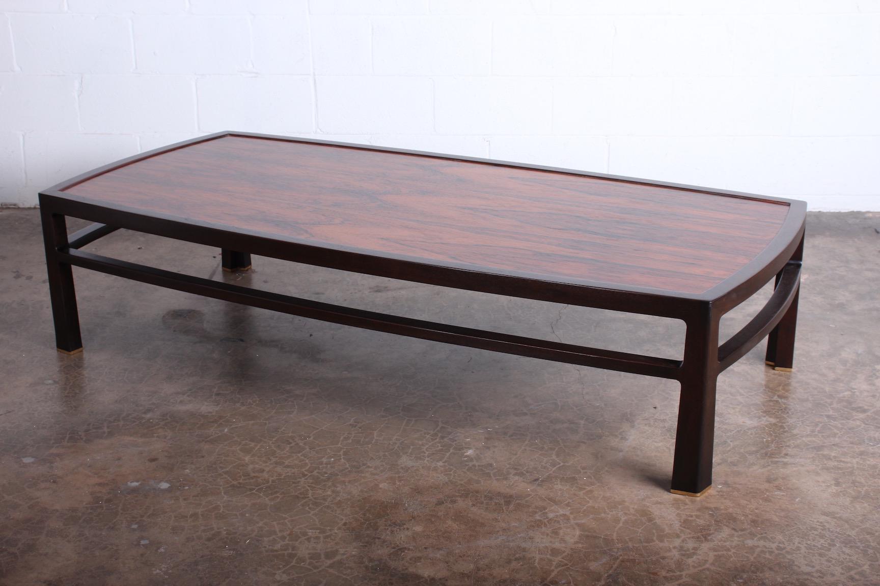 A large scale mahogany and rosewood coffee table designed by Edward Wormley for Dunbar.