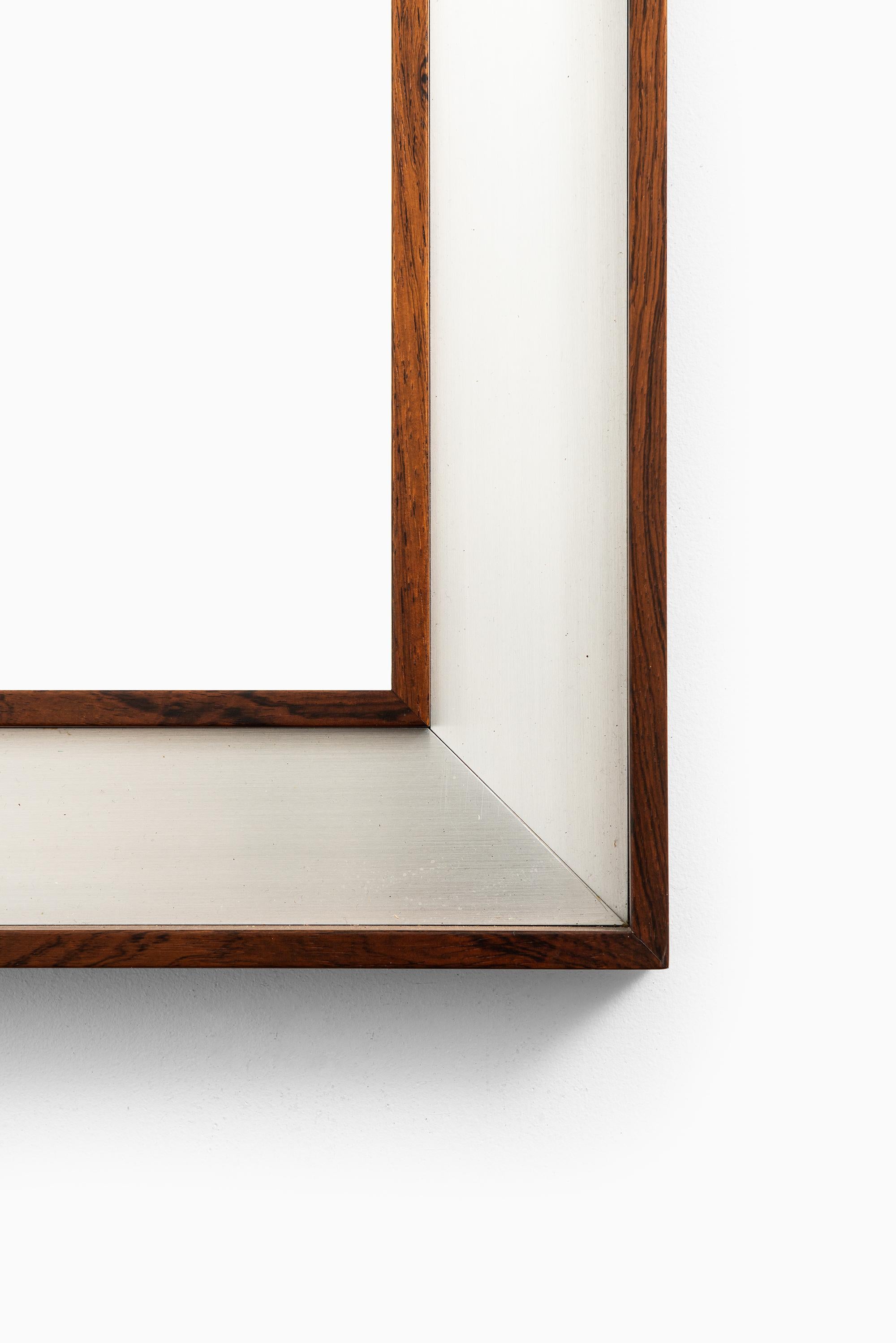 Large rosewood mirror with aluminium frame. Produced by Fröseke in Sweden.