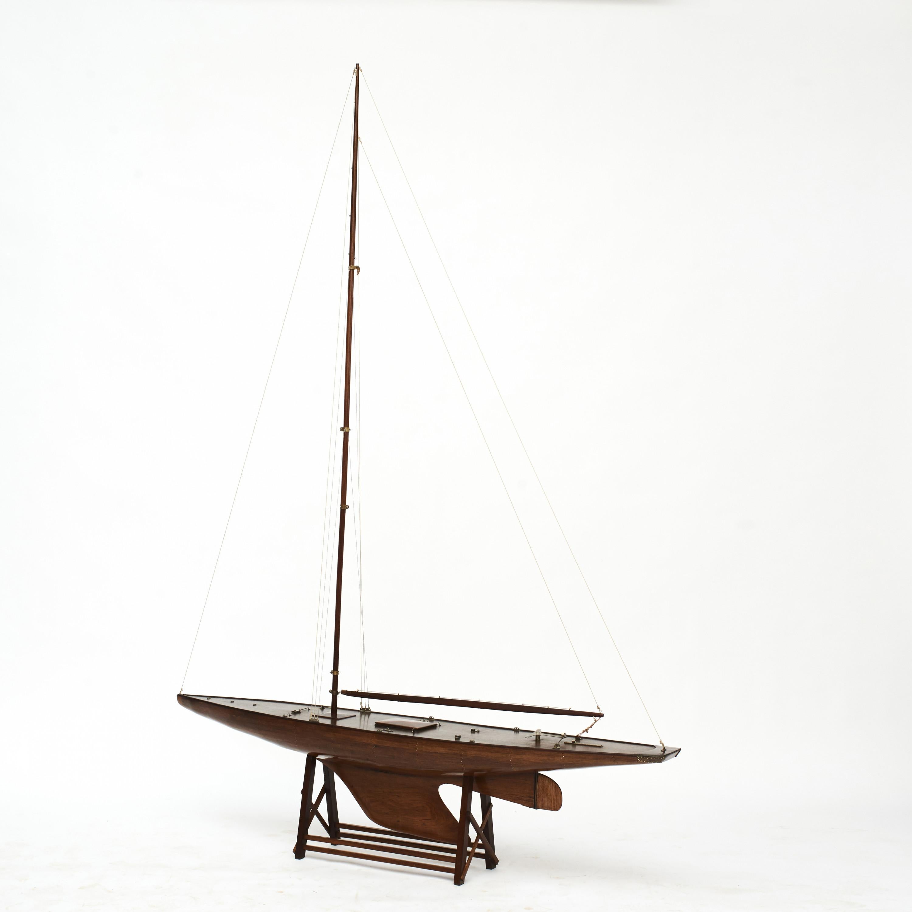 A very elegant wooden pond yacht ship model. High quality, hand-built.
Hull and mast made in santos mahogany with fine details.
Set onto a custom wood stand to hold the ship upright and stabile.
Denmark 1930-1950.

Height ex base 227 cm.