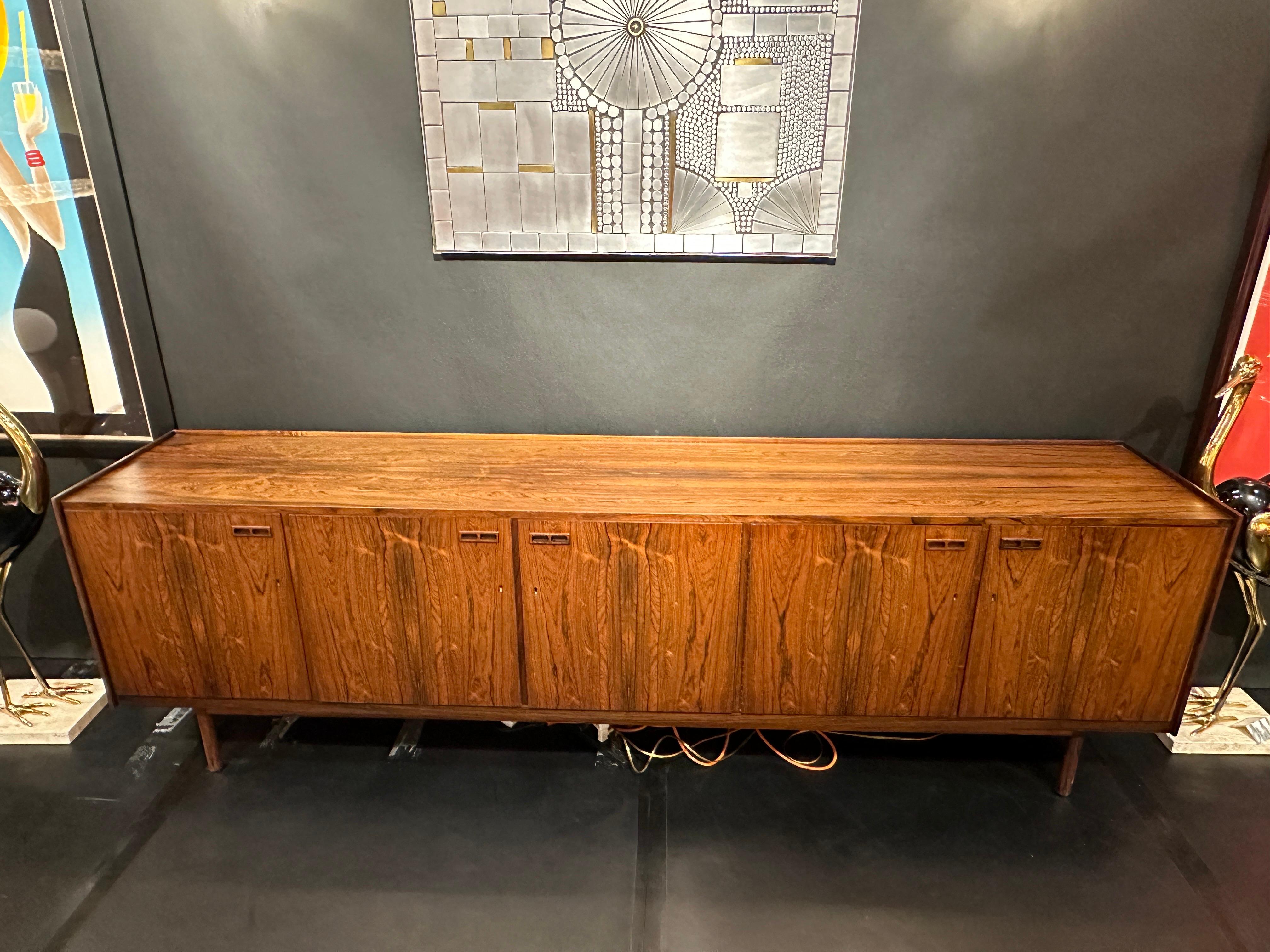 Extra long Brazilian Rosewood sideboard credenza with five doors and pull out velvet lined drawers.