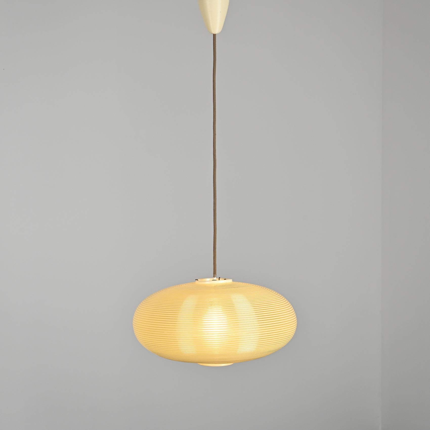 A large Rotaflex pendant light composed of a single flattened, ivory-colored round piece, including its bale cover, dating back to the 1960s.

The material used in crafting this pendant light is Rotaflex, an innovative plastic substance formed from