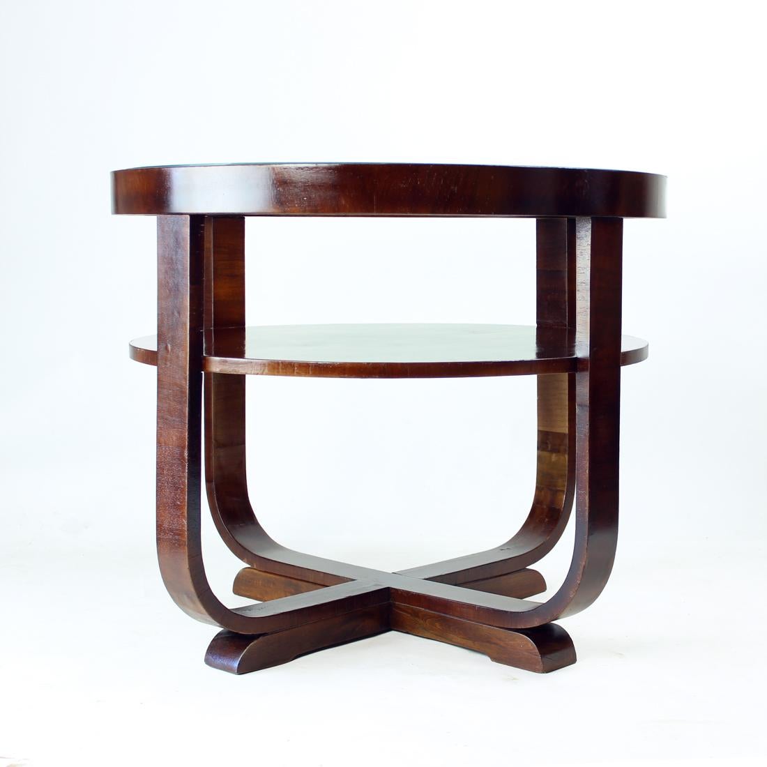 Beautiful and completely restored large art deco coffee table (or side table). Produced in Czechoslovakia in 1930s. The table is trully unique in style and construction. It is round and made of bent oak wood with walnut veneer and finished with a