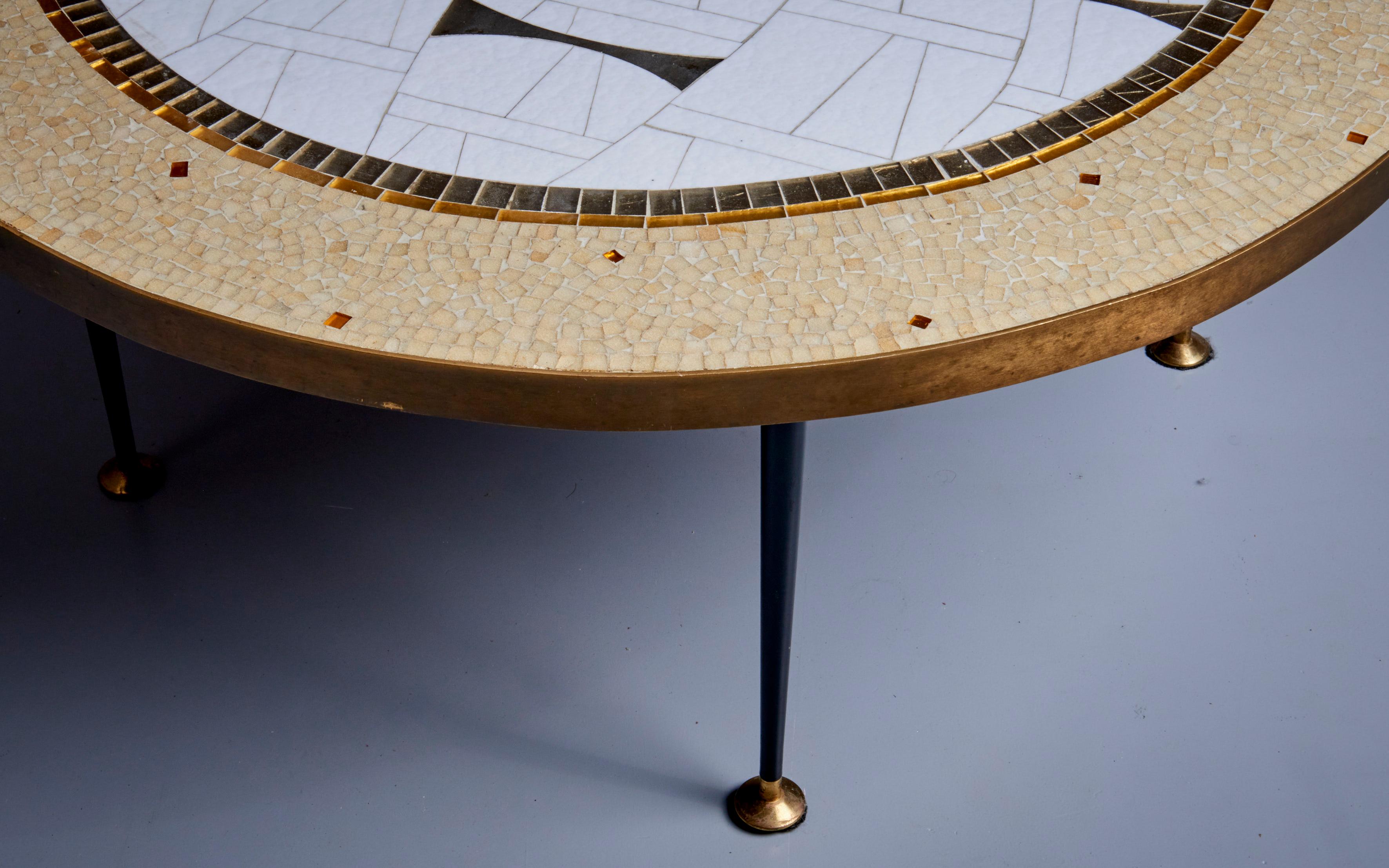 Round mosaic top coffee table with a brass band around it on four legs, by Berthold Müller. The top has an abstract composition and the brass has a lovely patina. Berthold Müller-Oerlinghausen (1893-1979) was a German sculptor who specialized in