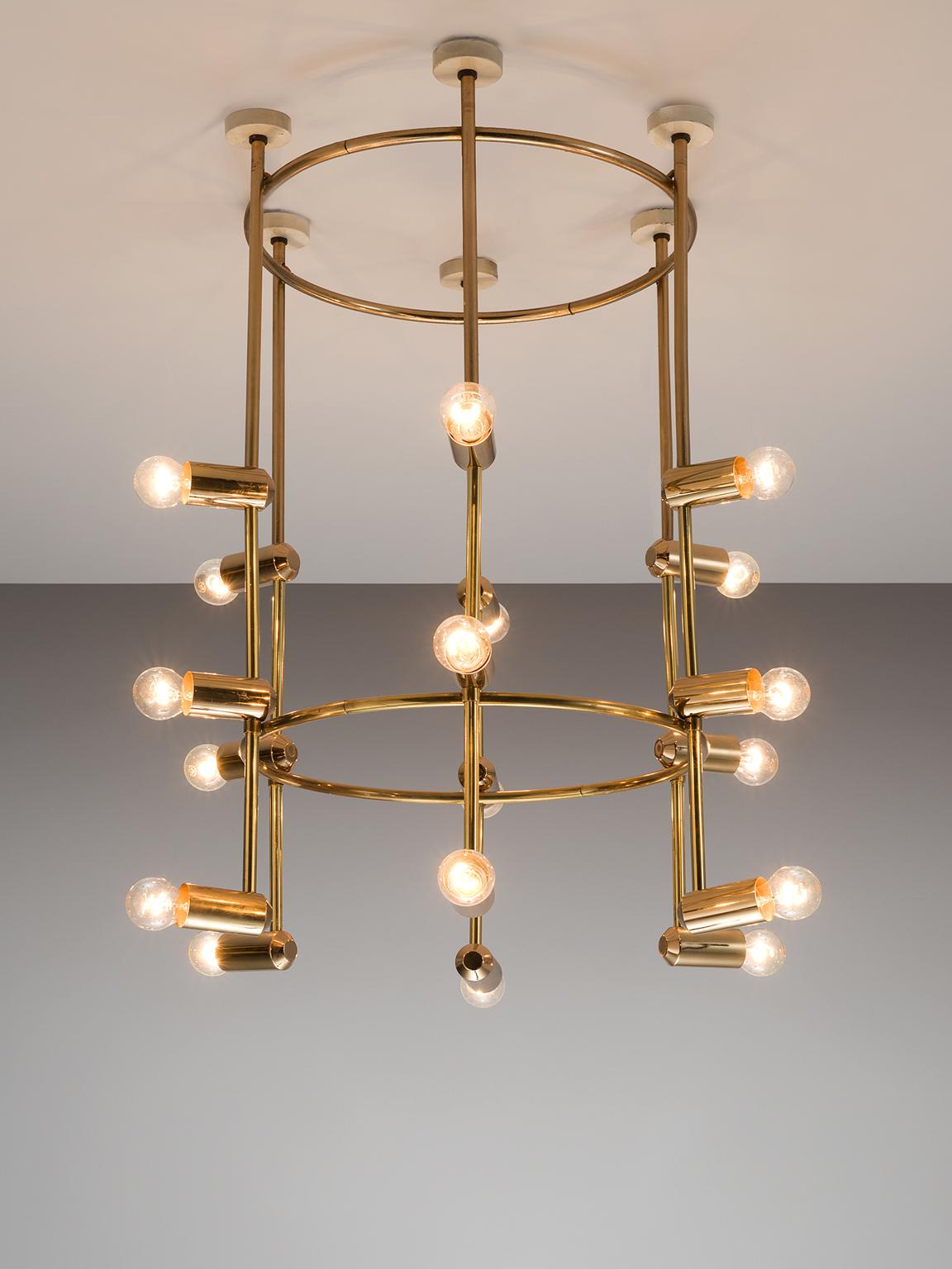 Chandelier, brass, 1960s, Switzerland.

This large yet delicate chandelier is Minimalist yet warm. The light consists of six brass stalks that are attached to a brass ring. There is a lower brass ring on the bottom giving the chandelier both