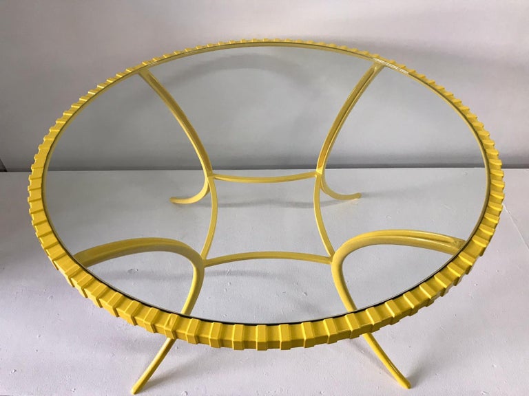 This totally awesome and vivid yellow round Klismos style table in cast aluminum made by Thinline. This is powder coated in a canary yellow and has a new 3/8 inch thick tempered glass top, perfect indoors or outdoors.

Thinline made this wonderful