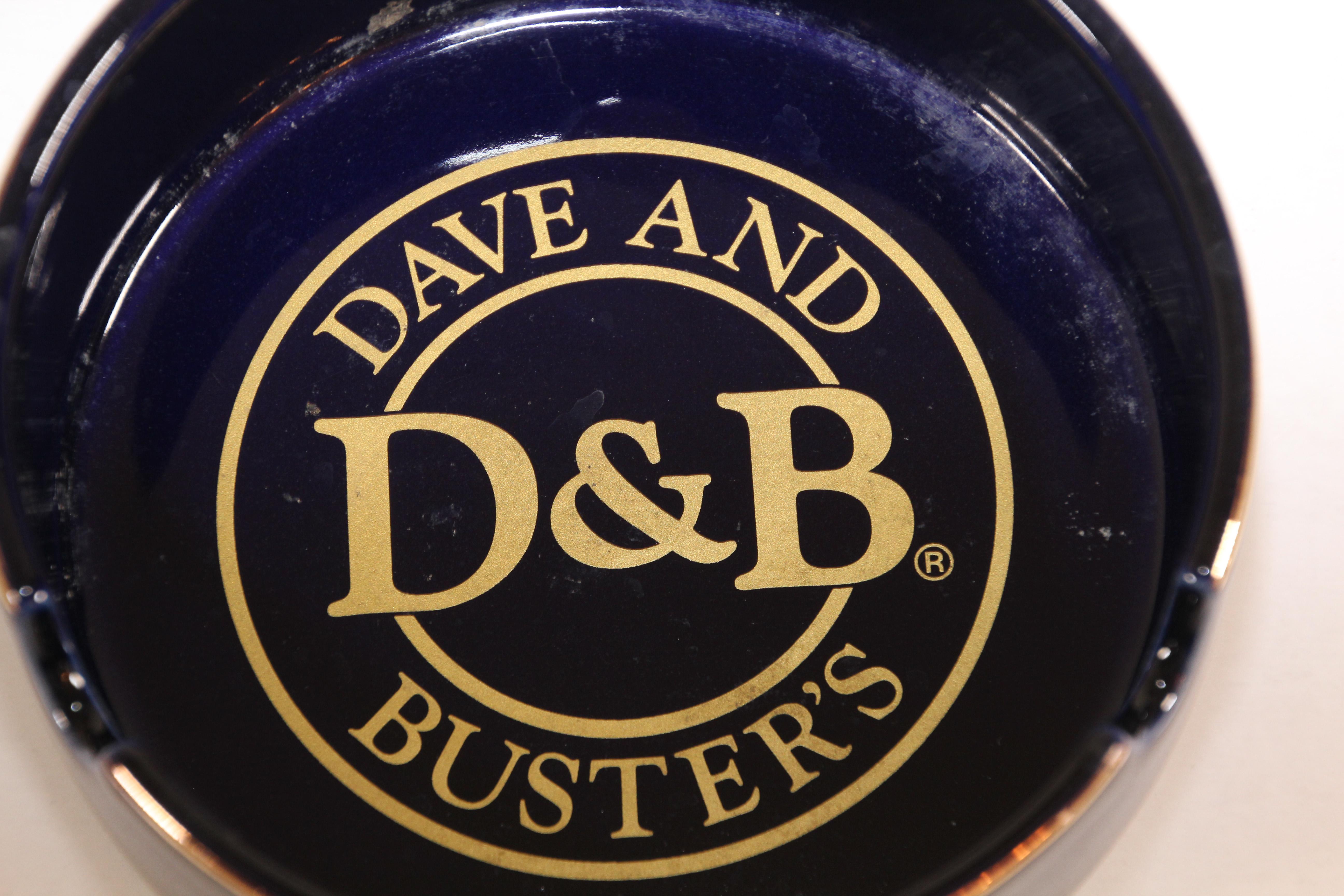 Large round blue and gold ceramic ashtray.
D&B, Dave and Busters advertising vintage ceramic ashtray.