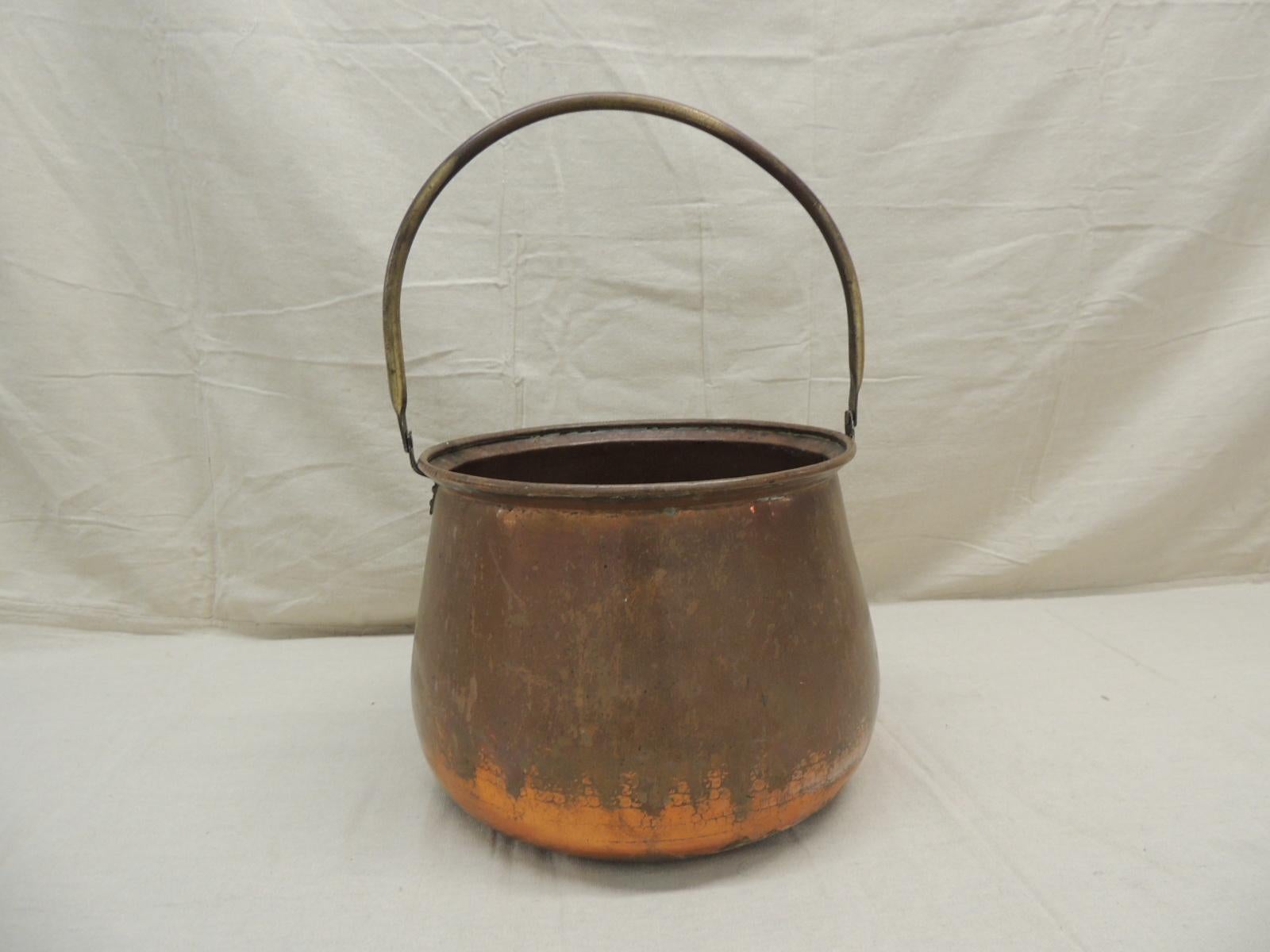 Large round copper and brass handle cauldron or log holder.
Measures: 13” D x 19” H (to the top of the handle).
   