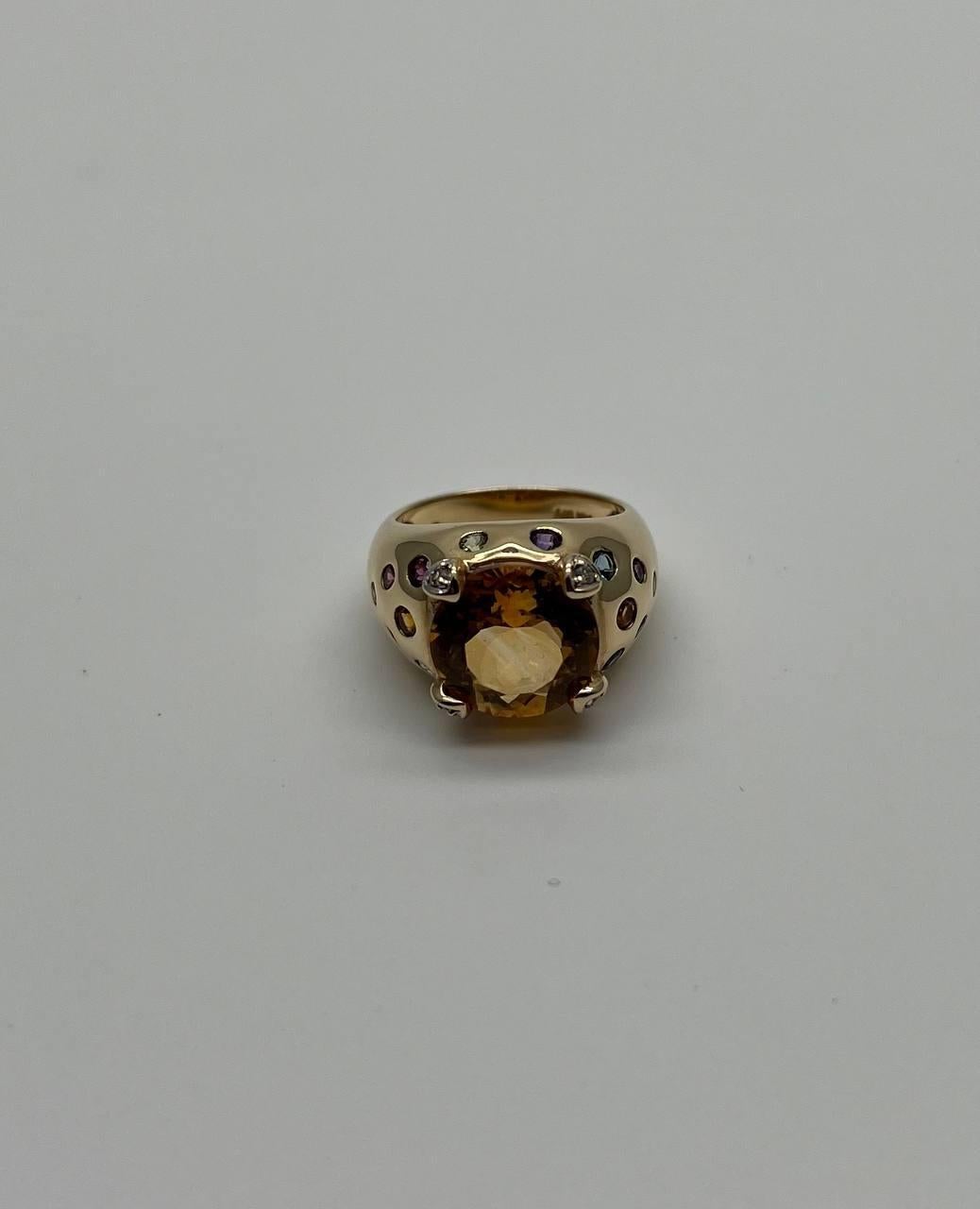 Elegant 14K Gold Ring with Citrine Gemstone. This striking ring features a large, oval-cut citrine gemstone. The band is adorned with intricate cut-out designs, adding a touch of sophistication. The gemstone is securely held by four prongs, ensuring