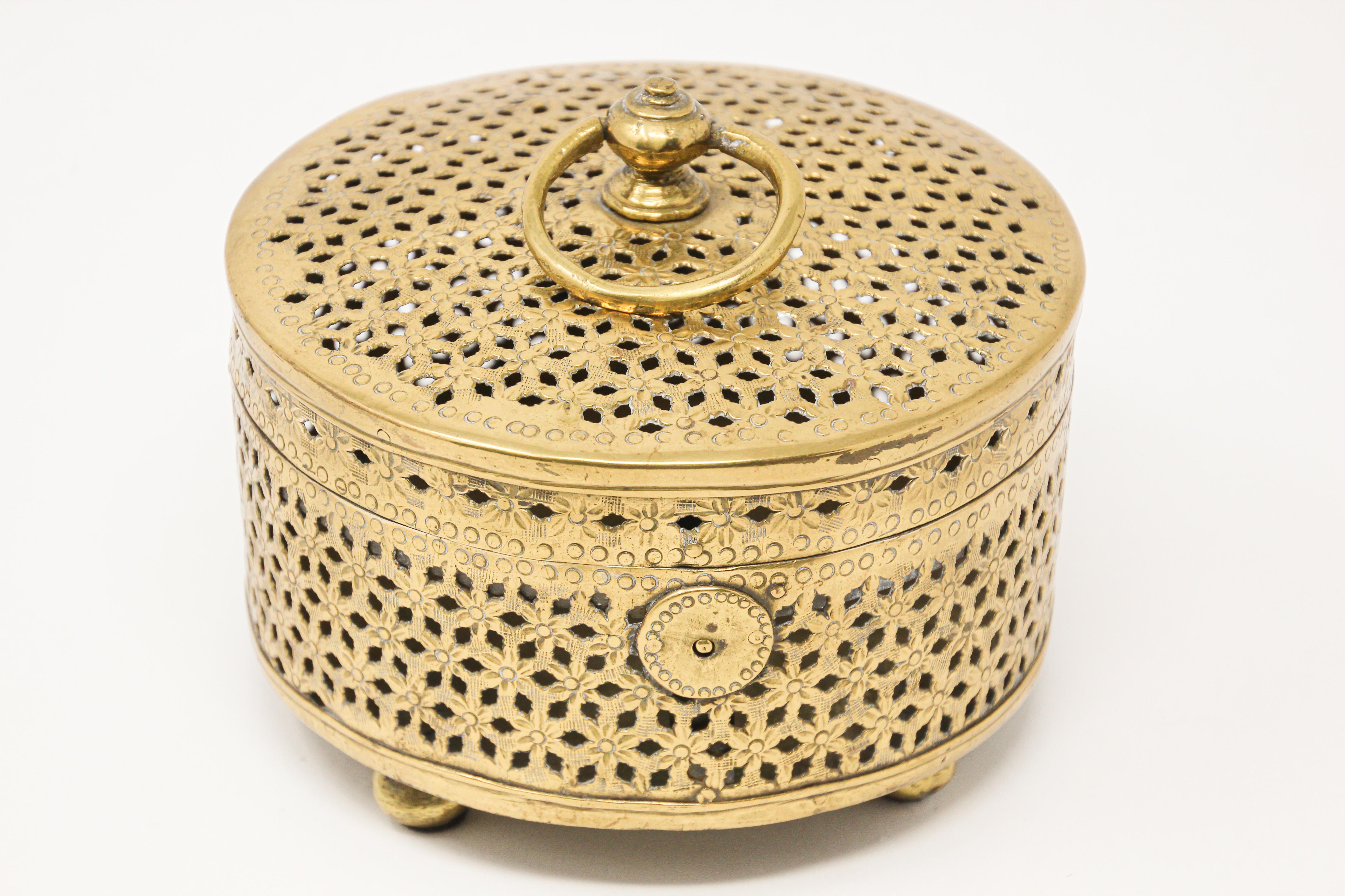 Handcrafted large Mughal style decorative round exquisite Incense holder polished brass box with lid, latch and handle delicately and intricately hand-hammered with floral, geometric designs.
This incense burner stands on four cast feet and has an