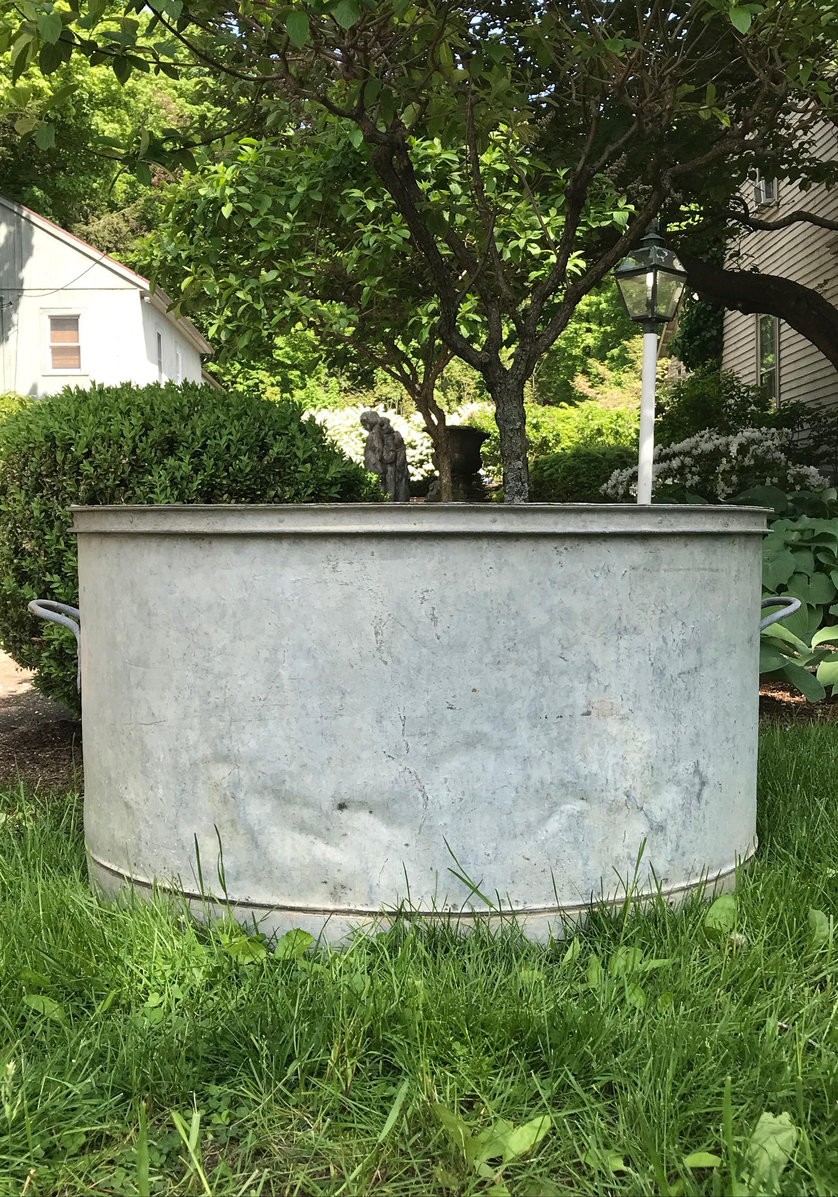 We love galvanized pieces because of their resistance to rust, as well as their steel grey/blue patina. This large tub is a beauty and very utilitarian because of its large size. It’s large enough to place a recirculating pump inside with a flume of