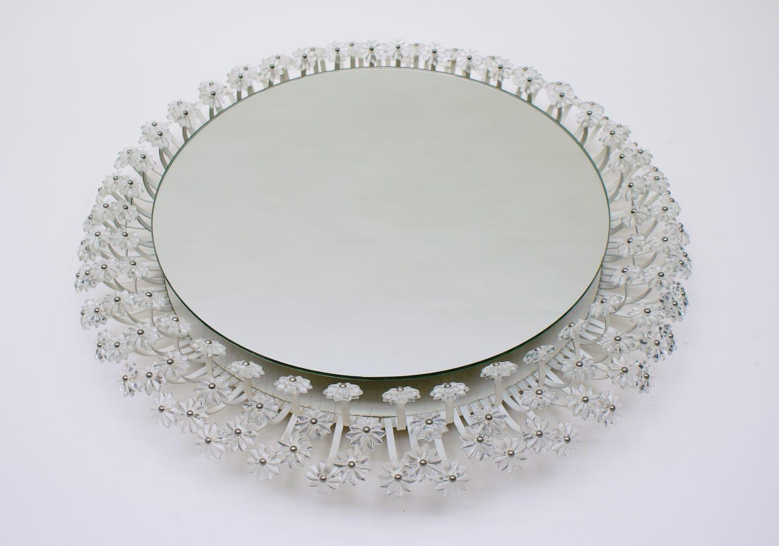 A beautiful large round flower wall mirror with illuminated background and hundreds of Lucite blossoms by Emil Stejnar for Rupert Nikoll, Austria. Fine working condition. Measures: Width 60 cm / 23.6 inches, 10 cm / 3.94 inches deep. This backlit