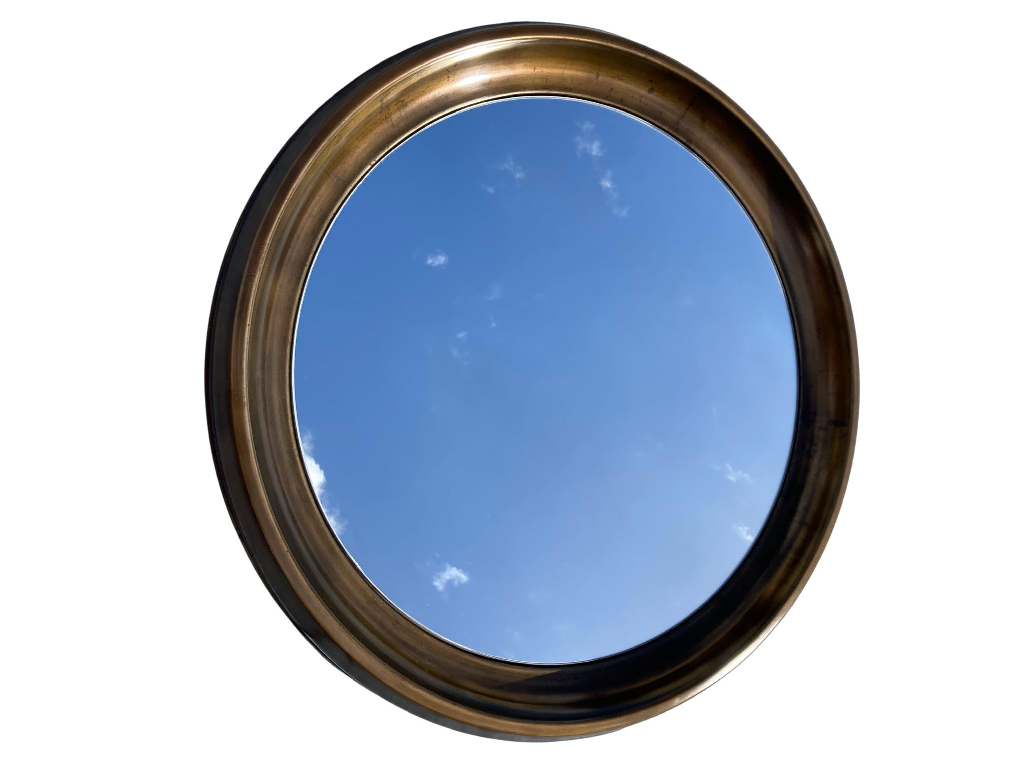 Large Mid-Century Modern mirror most likely made by Mastercraft.
Brass plated metal, the brass plating has a strong patina. Total weight is seventy pounds.
