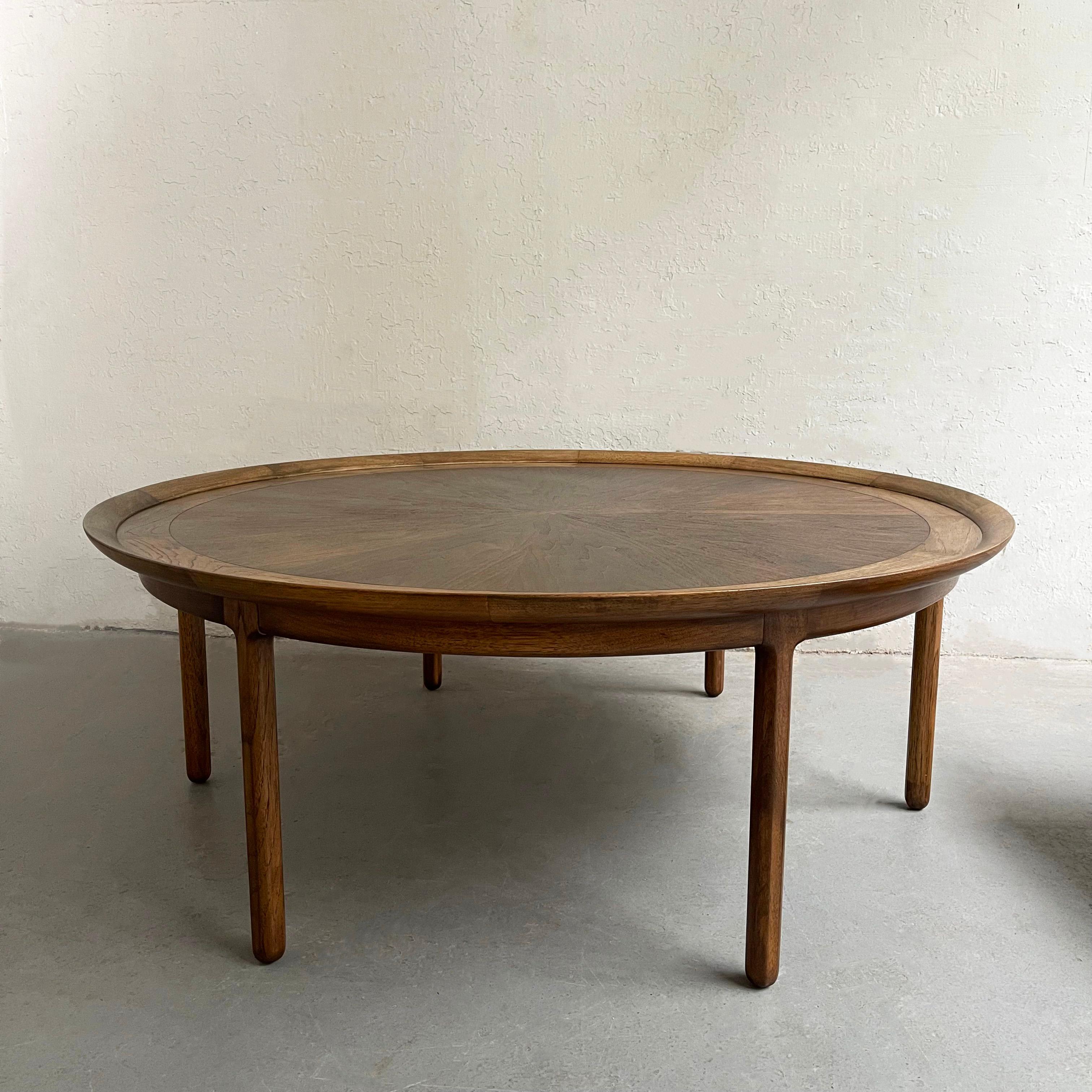 Impressively large, Mid-Century Modern, 54 inch round, coffee table by Tomlinson Furniture, Sophisticate Line features a recessed, bookmatched pecan wood top with butterfly joinery. The lip comes to 20.5 inches height.
