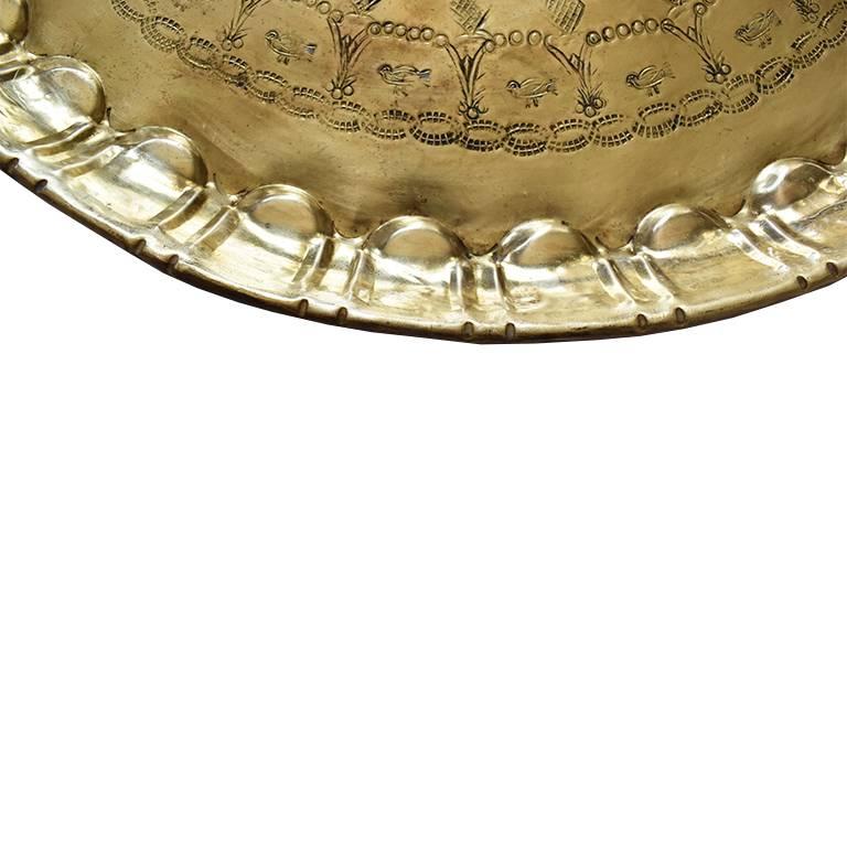 Middle Eastern, Moorish style polished heavy solid hammered brass tea tray. Finely hand-carved, with beautiful designs. The underside has a hanging hook, so the piece could be displayed on a wall. But would also make a gorgeous accent to a coffee
