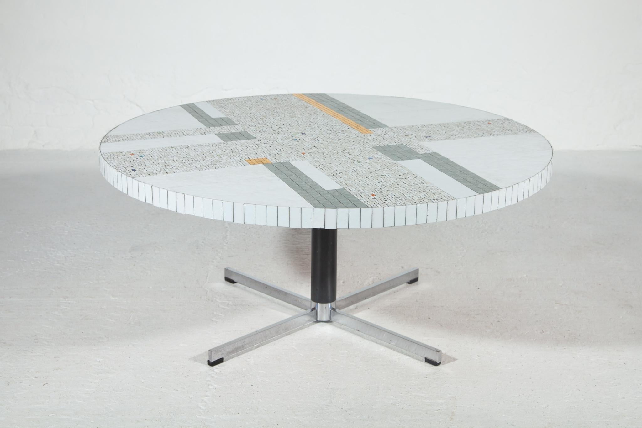 Beautiful round Mosaic top coffee table designed by Berthold Müller one of the most beautiful examples. The mosaic pattern on top is a fascinating work in modern style and contrast in white and gold and other color accents in grey, blue, red, green