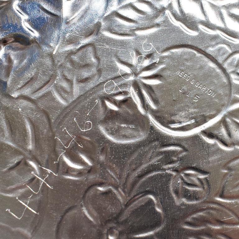 Decorated with embossed strawberries and leaves, this large round serving tray will be a fabulous piece for use at your next party. Created from silverplate, it will be great for charcuterie or crudites. The bottom is marked Reed & Barton 115.